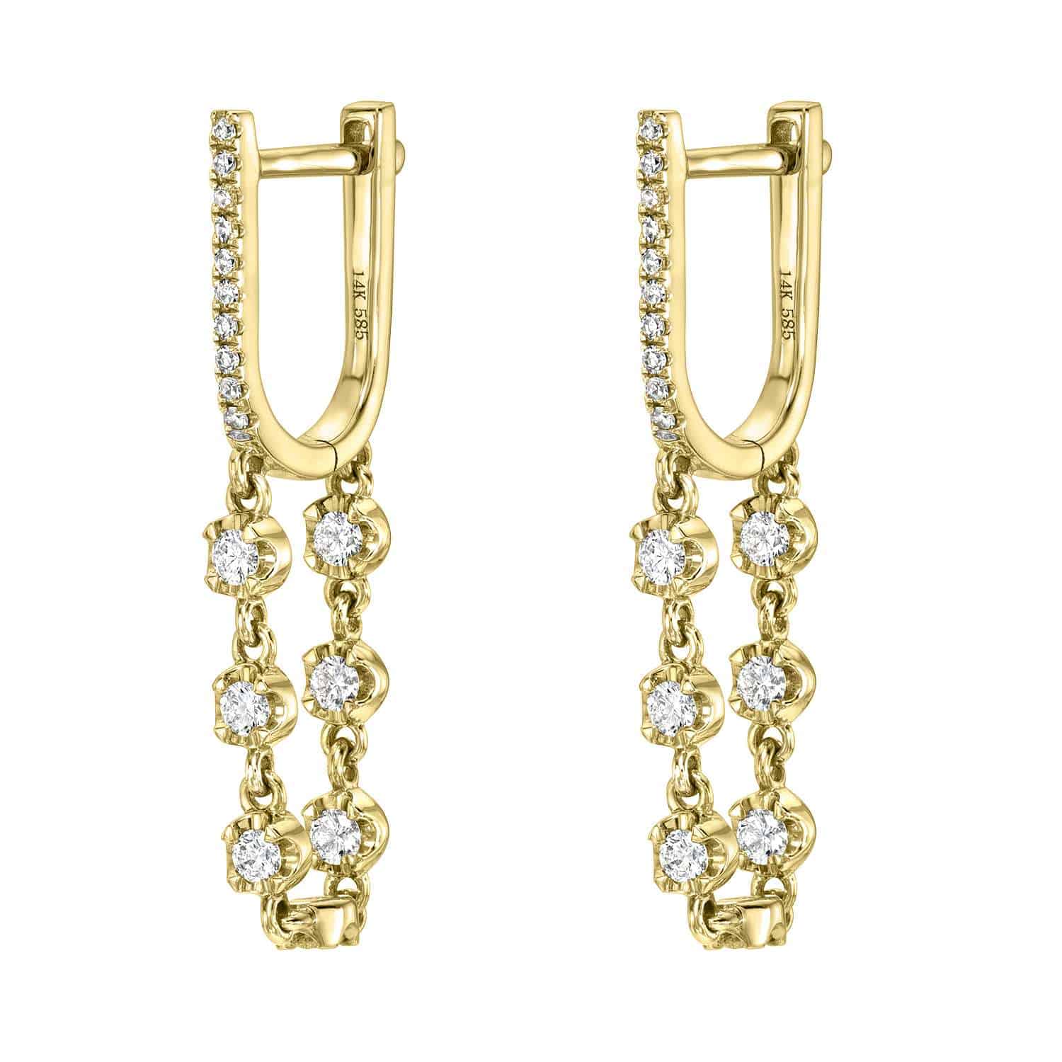 Diamond Loop Huggies featuring two delicate dangling chains, each accented with round, sparkling white stones. These modern gold hoop earrings are adorned with additional small stones along the front of the hoops, showcasing the timeless elegance synonymous with Janet Heller Fine Jewelry. Product: Diamond Loop Huggies (EAR-213-Y) | $970.00.