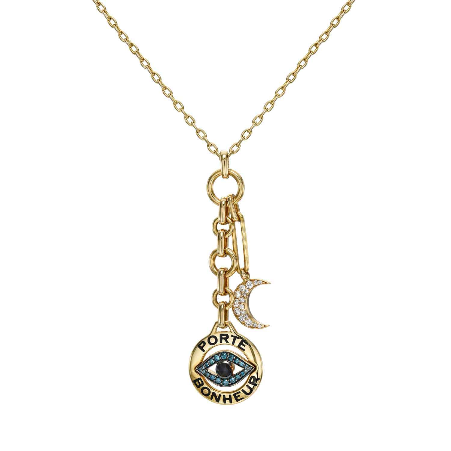 The Small Diamond Porte Bonheur Necklace is an exquisite gold piece featuring three charms: a circular one with PORTE BONHEUR and an eye, a small moon adorned with sparkling stones, and an oblong chain link—ideal for those who appreciate unique custom accessories.