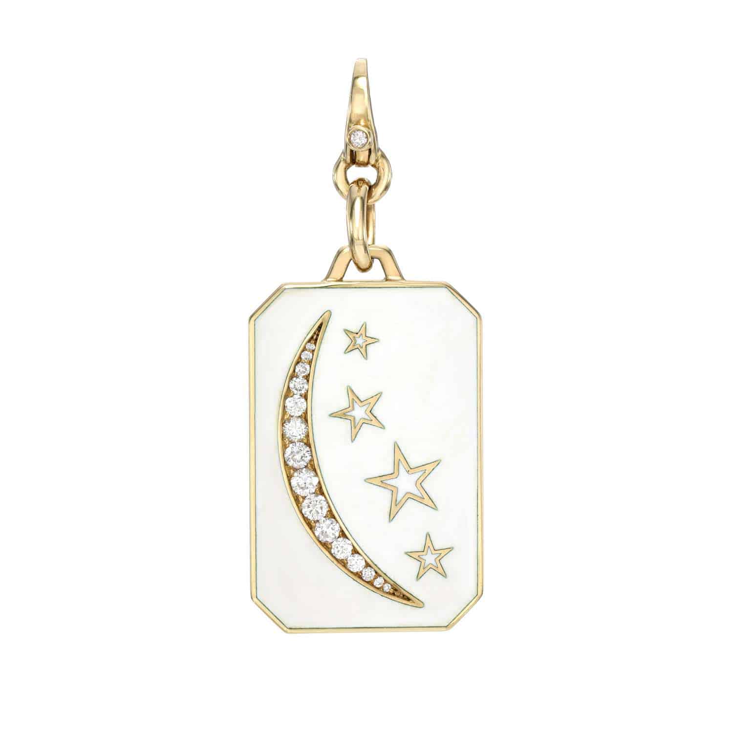 The Janet Heller Fine Jewelry collection introduces the Enamel Star & Moon Charm, featuring a gold and white enamel rectangular design with a crescent moon and three crystal-studded stars. A top gold link allows for easy attachment, adding elegance to any ensemble.