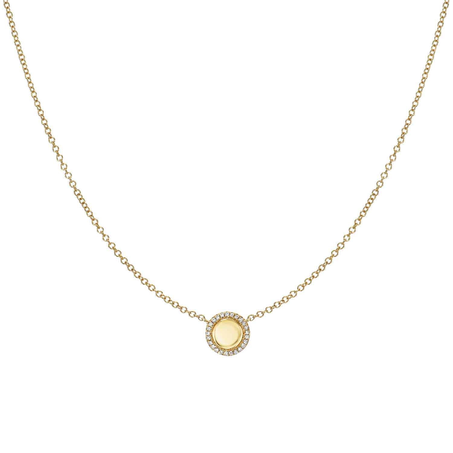 The Engravable Kennedy Necklace from Janet Heller Fine Jewelry is crafted in 14KT gold.  The necklace features a delicate chain with an engraveable round pendant surrounded by small diamonds perfect for engraving a personalized message.  The necklace can be worn alone or layered with other necklaces and chains.