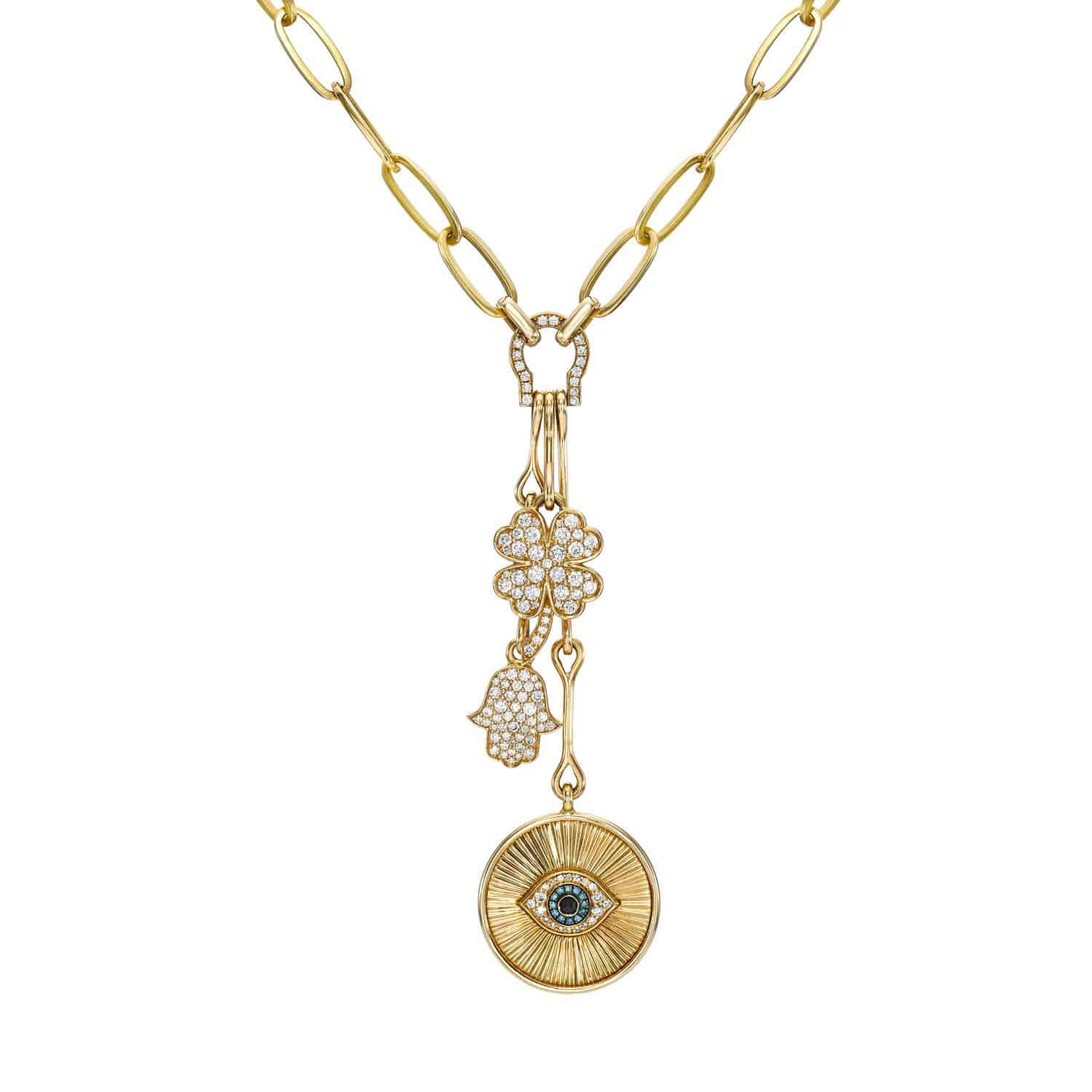 Explore the Evil Eye Medallion Necklace from Janet Heller Fine Jewelry. This refined gold chain showcases three unique charms: an eye pendant, a pave diamond hand, and a flower. Its exquisite design offers rich texture and shape. Contact us for customizations to personalize your piece.