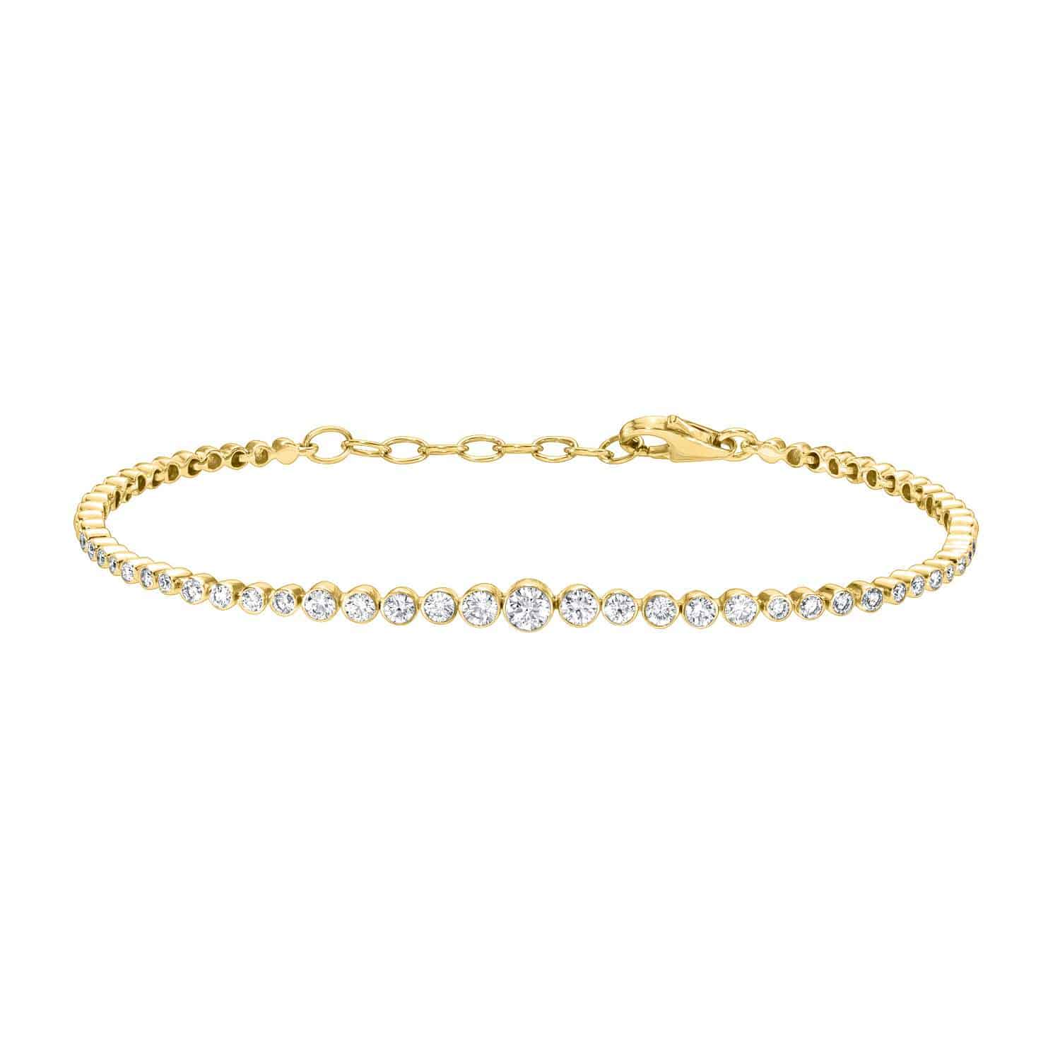 The Graduating Bezel Diamond Bracelet is a fine jewelry piece featuring small round diamonds on a gold chain with a lobster clasp and adjustable length, offering a simple, elegant design that highlights the diamonds prominently along its curve.