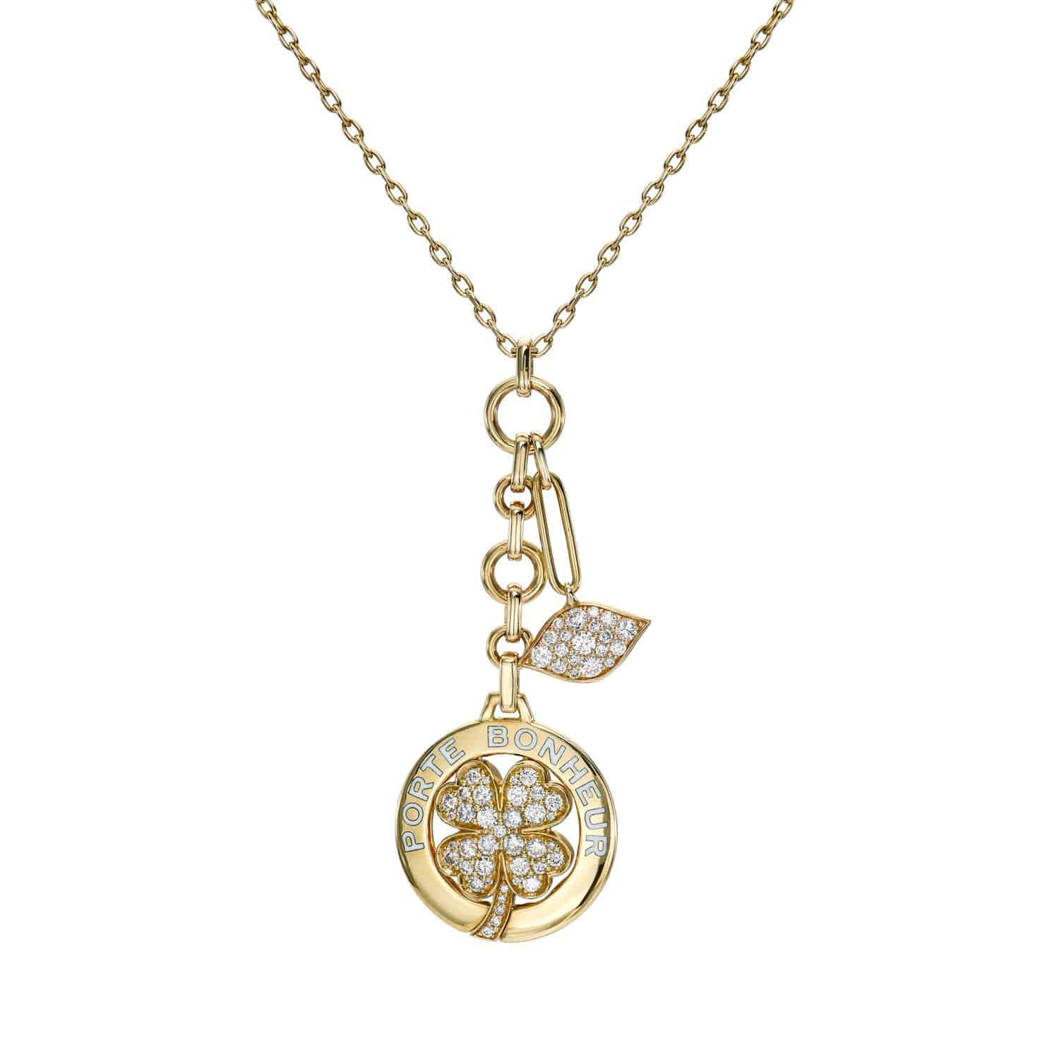 The Large Diamond Porte Bonheur Necklace showcases a gold chain with a circular clover pendant, embedded with small diamonds and engraved Porte Bonheur. A smaller diamond-studded leaf charm hangs above, ideal for anyone seeking customizable, subtle jewelry to express their unique style.