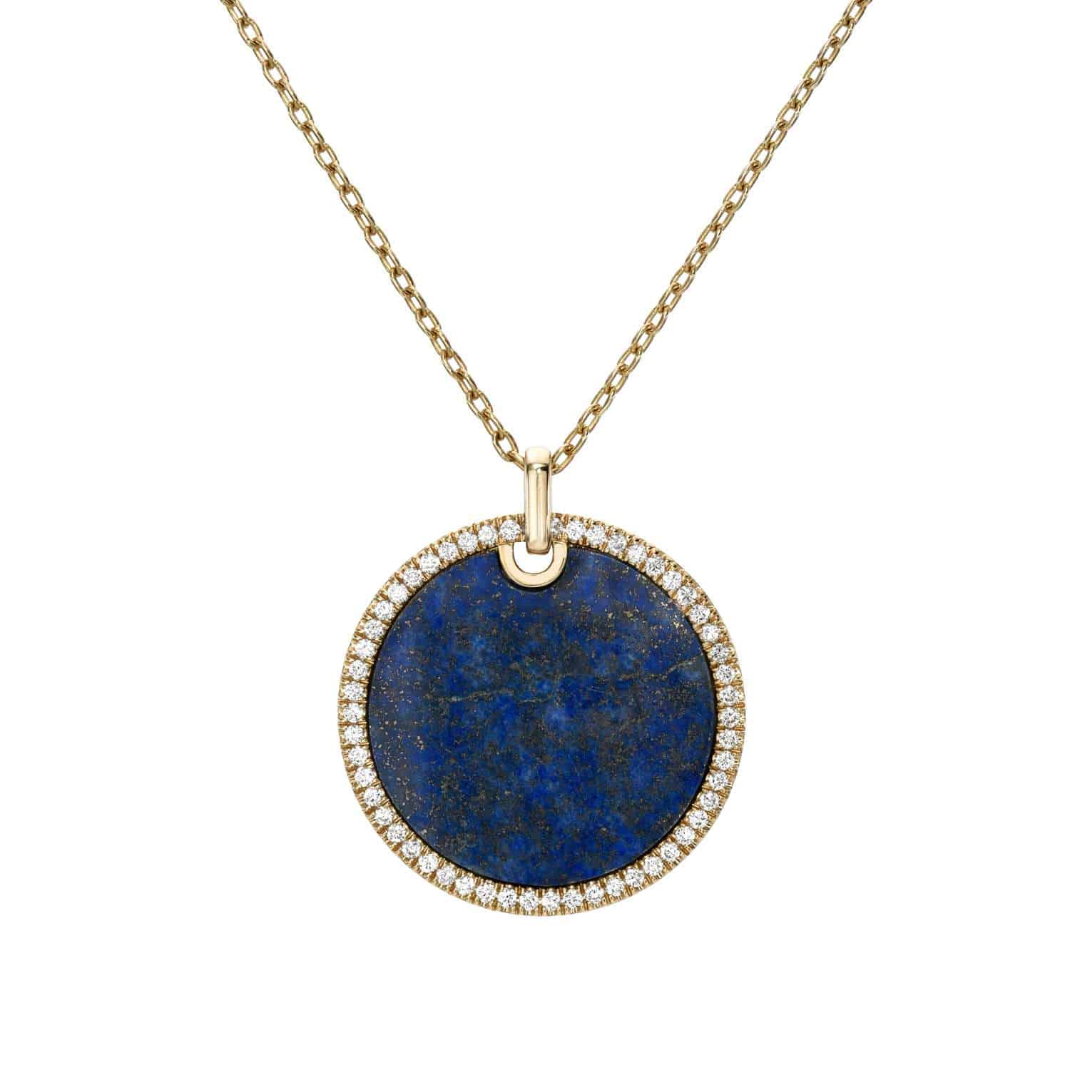 The Large Lapis Pendant Necklace from Janet Heller Fine Jewelry is crafted in 14KT gold. The round lapis charm is edged in diamonds. The necklace can be worn alone or layered with other chains.