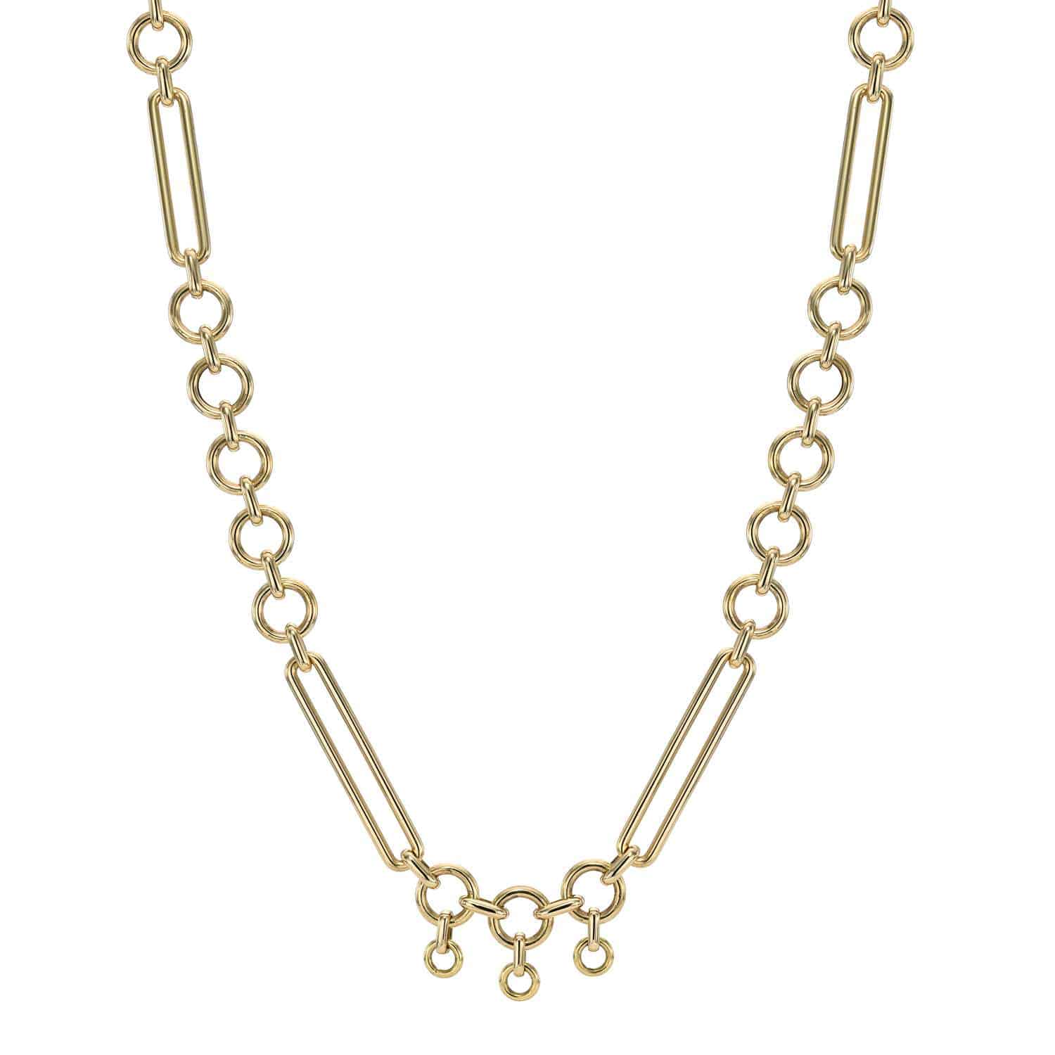 The Lucy Chain by Janet Heller Fine Jewelry features alternating large rectangular and small circular links, with a trio of small circular charms at the center for added symmetry and sophistication.