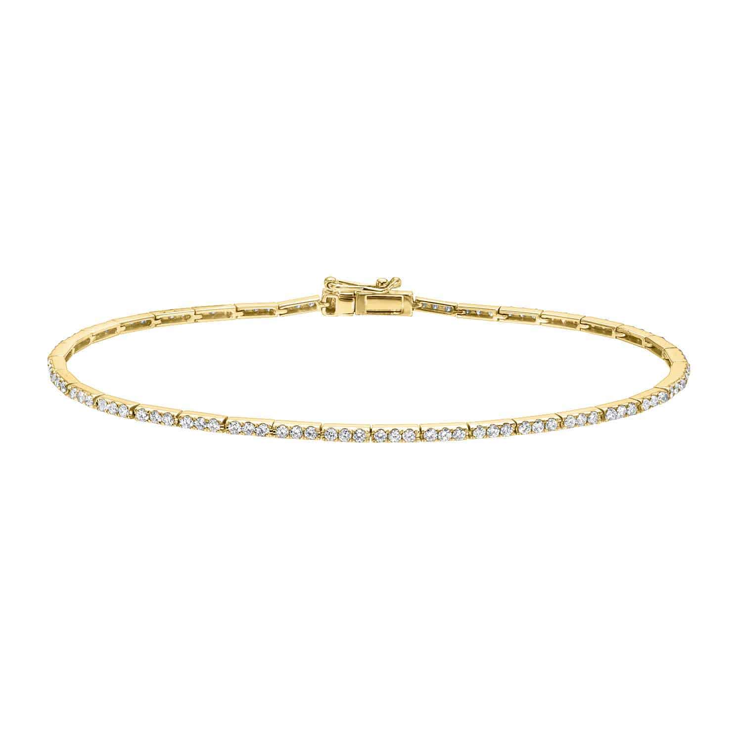 A thin Micro Diamond Tennis Bracelet by Janet Heller Fine Jewelry, featuring a row of small, round-cut diamonds and a secure clasp, is displayed on a plain white background.