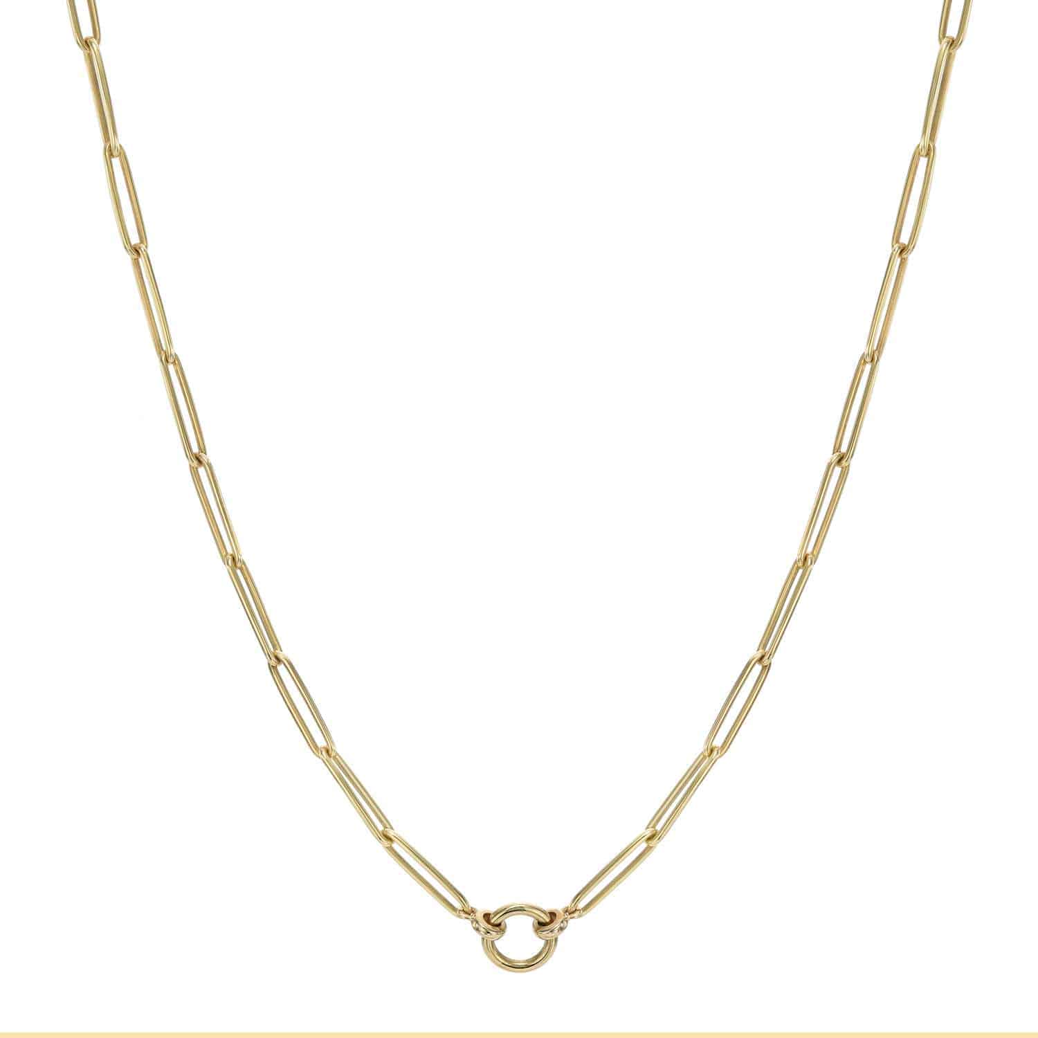 The Rome Chain features elongated gold paperclip links and a round center clasp set against a white background. Customize it with personalized charms from Janet Heller Fine Jewelry for a unique look.