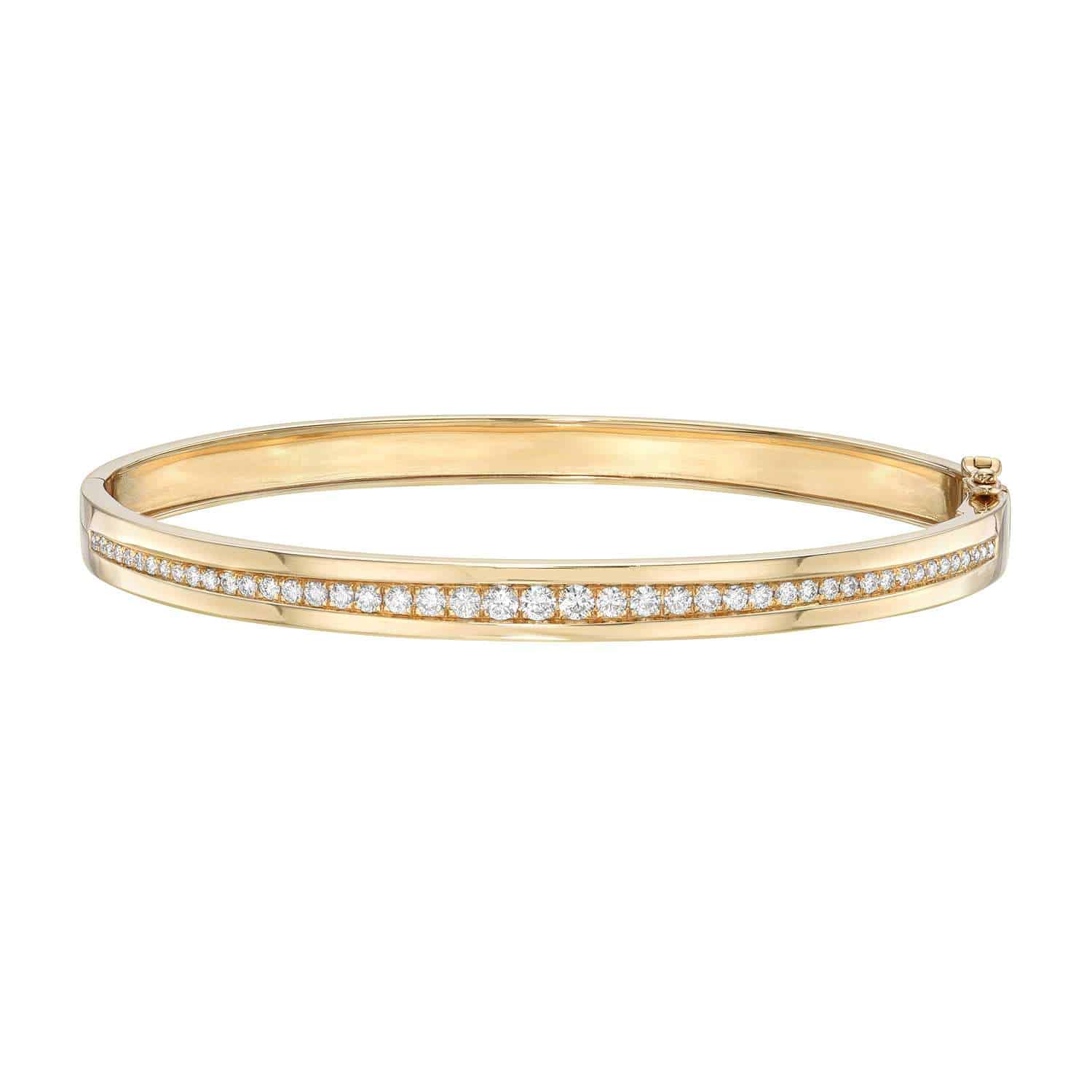 The Single Row Diamond Bangle by Foundry Fine Jewelry is an elegant gold bracelet featuring a line of sparkling diamonds. It combines simplicity and luxury, with customization options to make it uniquely yours.