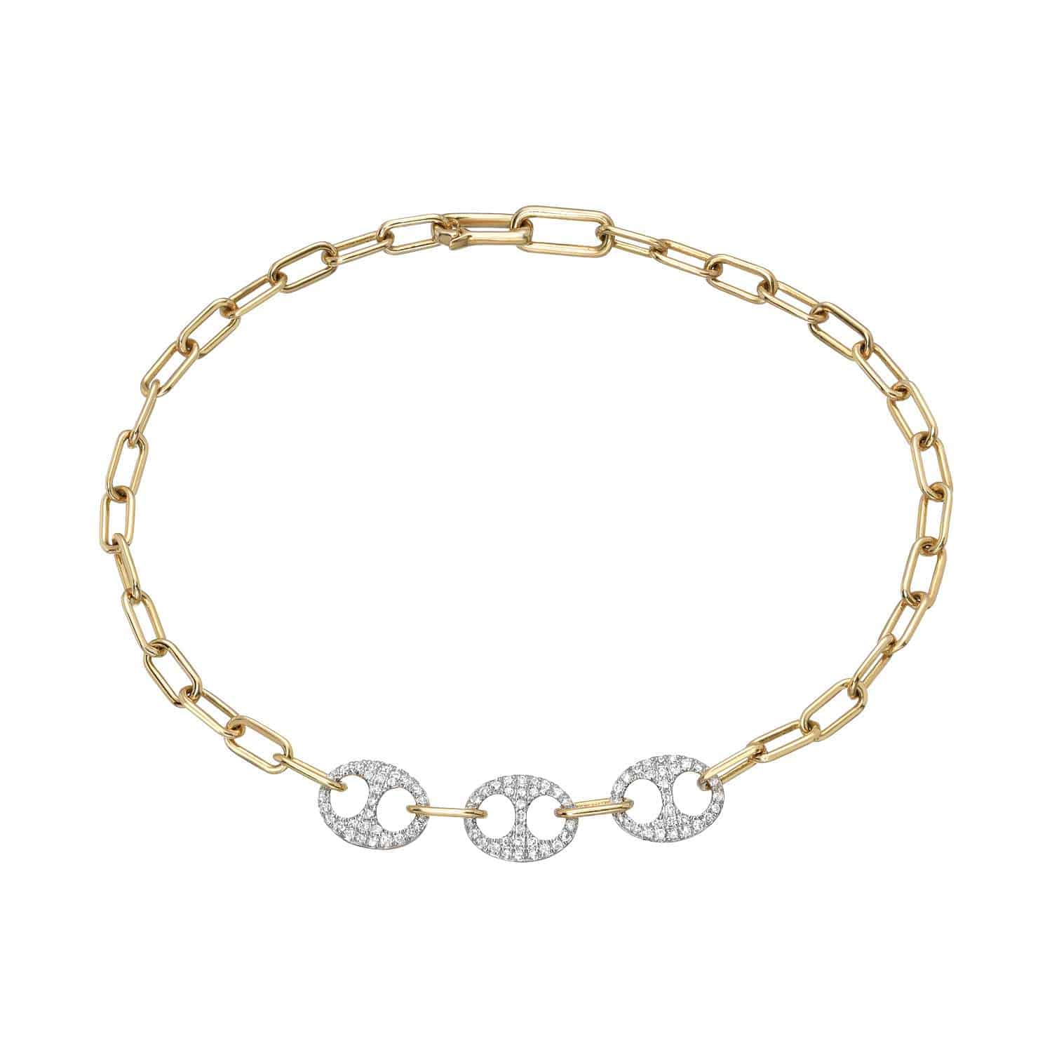 The Two Tone Diamond Link Bracelet from Janet Heller Fine Jewelry is crafted in 14KT gold.  The bracelet features  three interlocking circular links embellished with diamonds.  The bracelet can be worn on its own or stacked wit other bracelets.