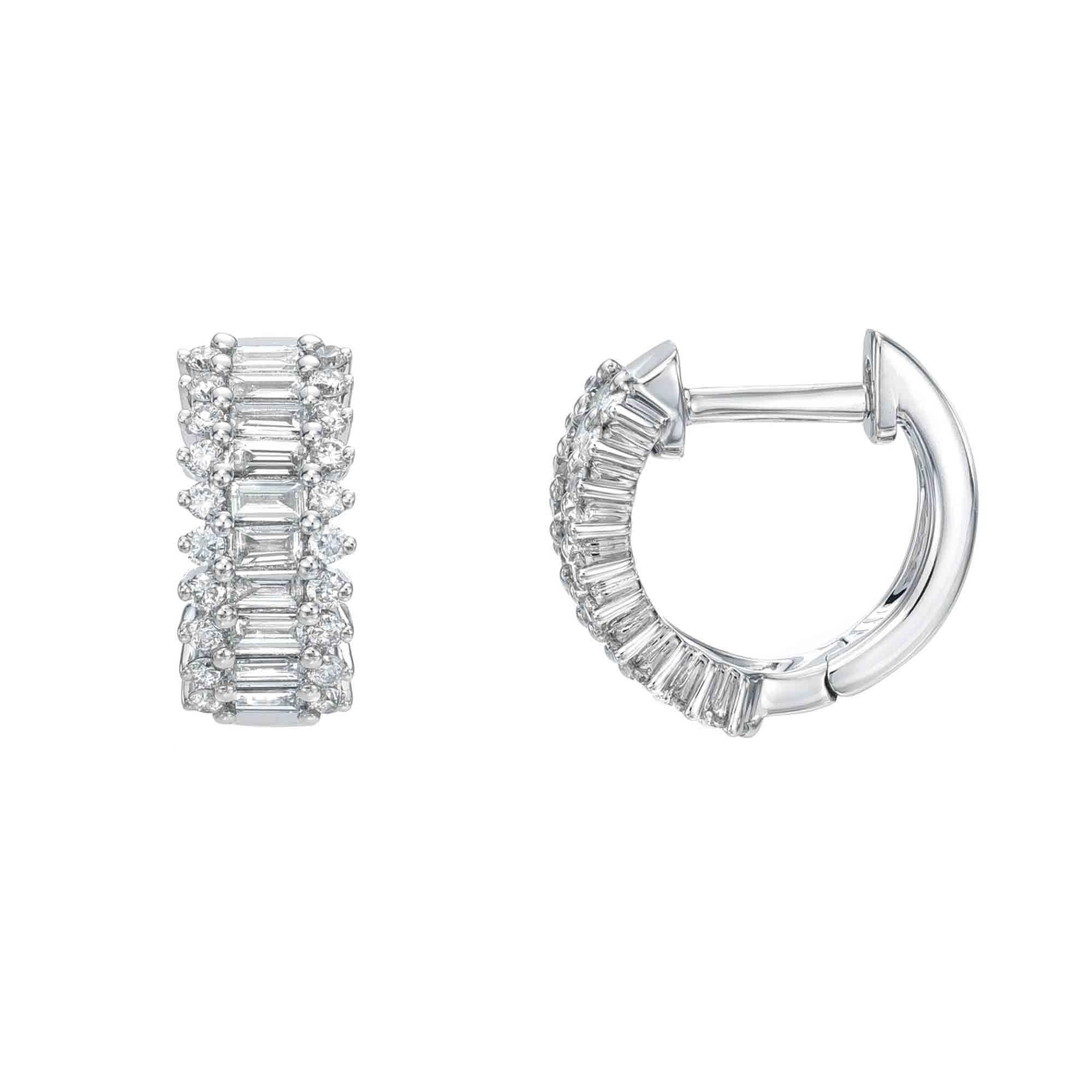The Diamond Colby Huggies from our fine jewelry collection are silver hoop earrings with a detailed design of rectangular and round clear gemstones. One earring is shown front-facing, highlighting the pattern, while the other is side-viewed to show its curved shape and clasp.