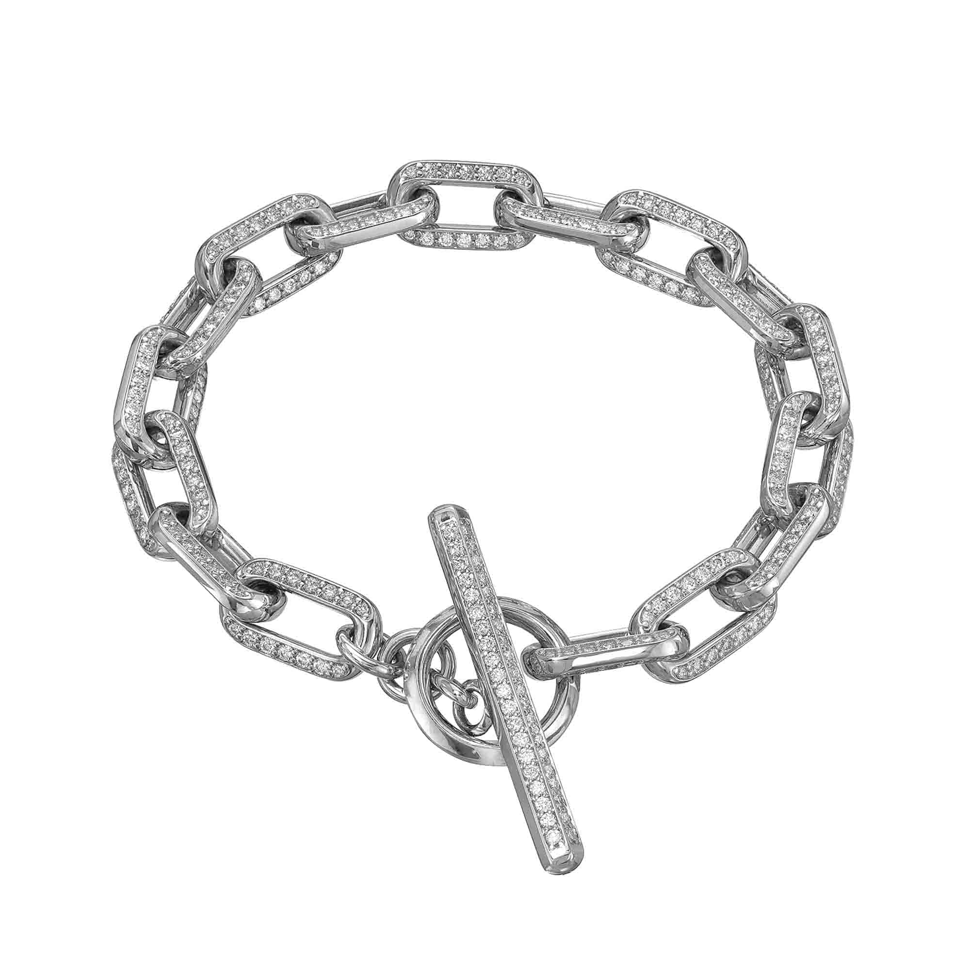 The Full Square Diamond Toggle Link Bracelet from Janet Heller Fine Jewelry is a sophisticated silver chain bracelet with rectangular links, each adorned with sparkling gemstones. Its design is completed by a toggle clasp that features a bar fitting into a circular opening.