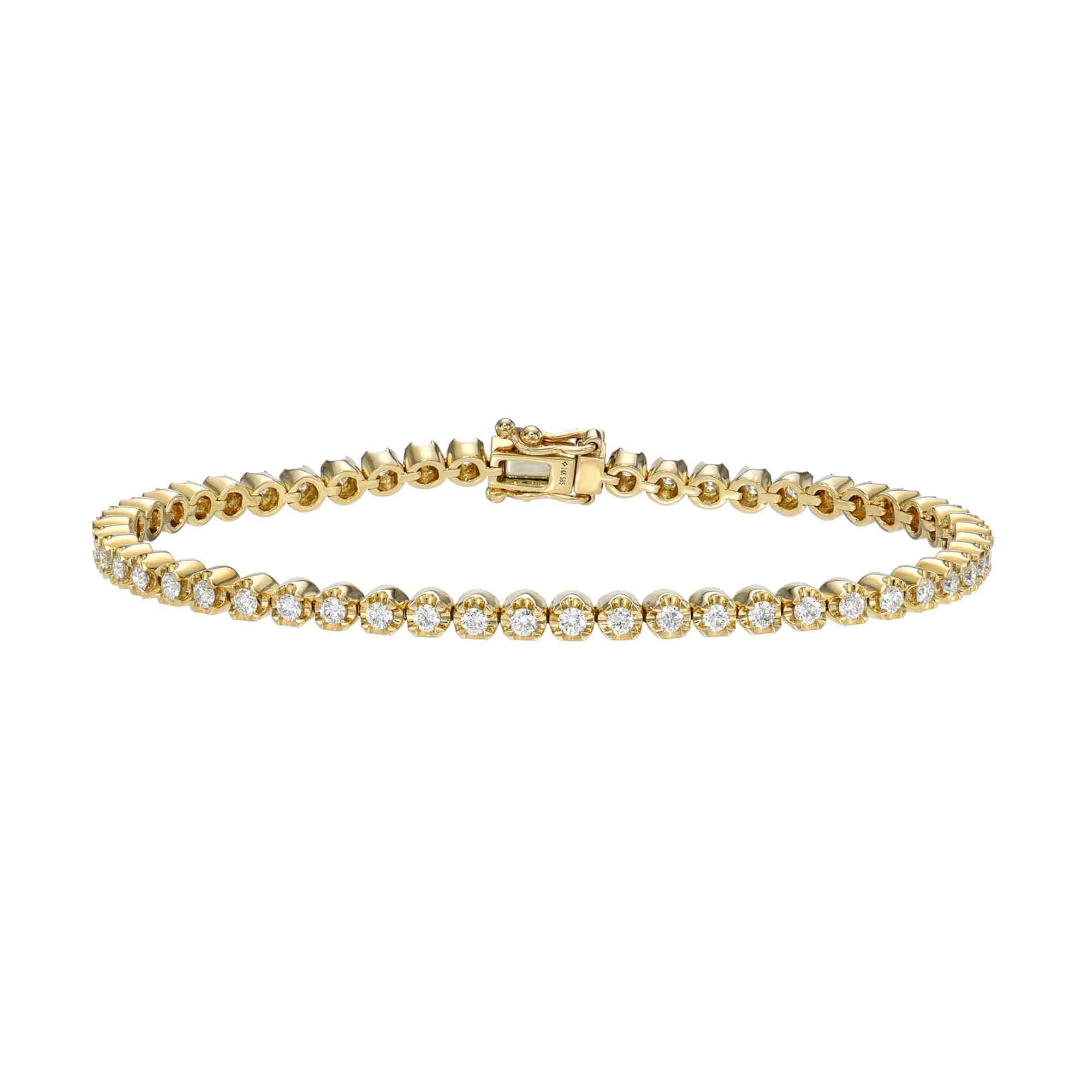 The Diamond Blakely Tennis Bracelet, a gold piece adorned with small round diamonds, is elegantly showcased against a white background. Its visible clasp enhances the design and offers endless customization possibilities.