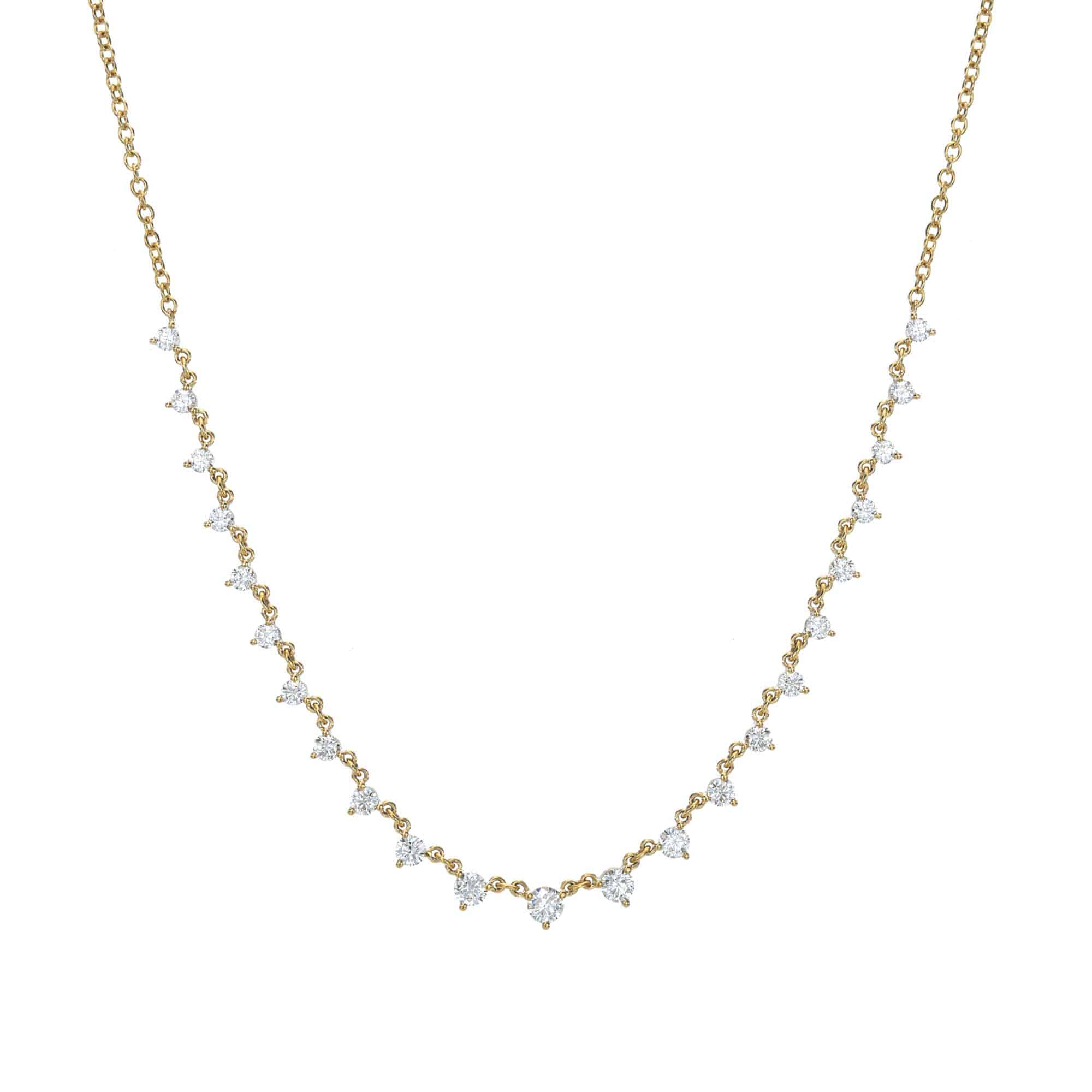 Explore the elegance of a Janet Heller Fine Jewelry piece: the Diamond Cara Necklace. This delicate gold chain, adorned with evenly spaced diamond-shaped crystals, gracefully curves with minimalist sophistication against a plain white backdrop.