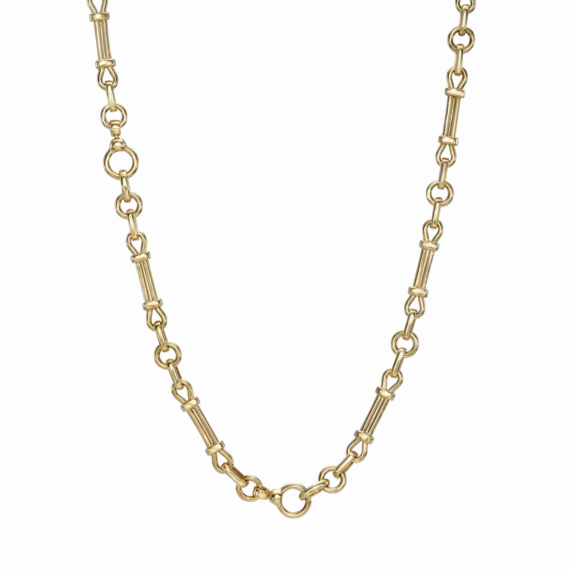 The Lisbon Chain from Janet Heller Fine Jewelry is a gold necklace featuring an elegant mixed chain design with alternating small circular links and longer bar-like segments. This intricate piece forms a continuous loop, beautifully showcasing its crafted charm.