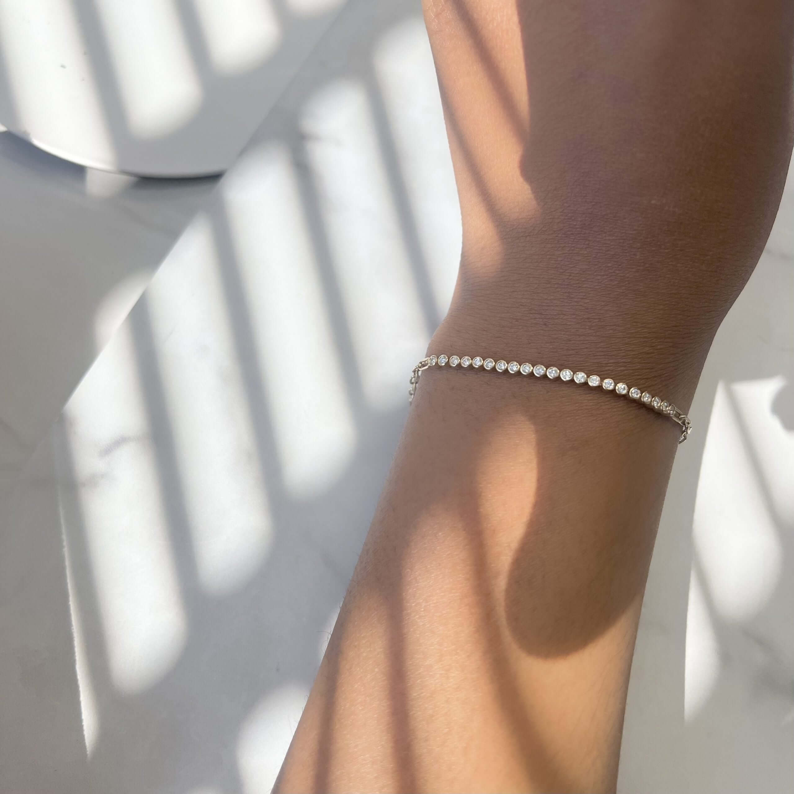 The Diamond Poppy Bracelet from Janet Heller Fine Jewelry features 21 round diamonds on a link chain.  The bracelet can be worn alone or stacked with other bracelets.