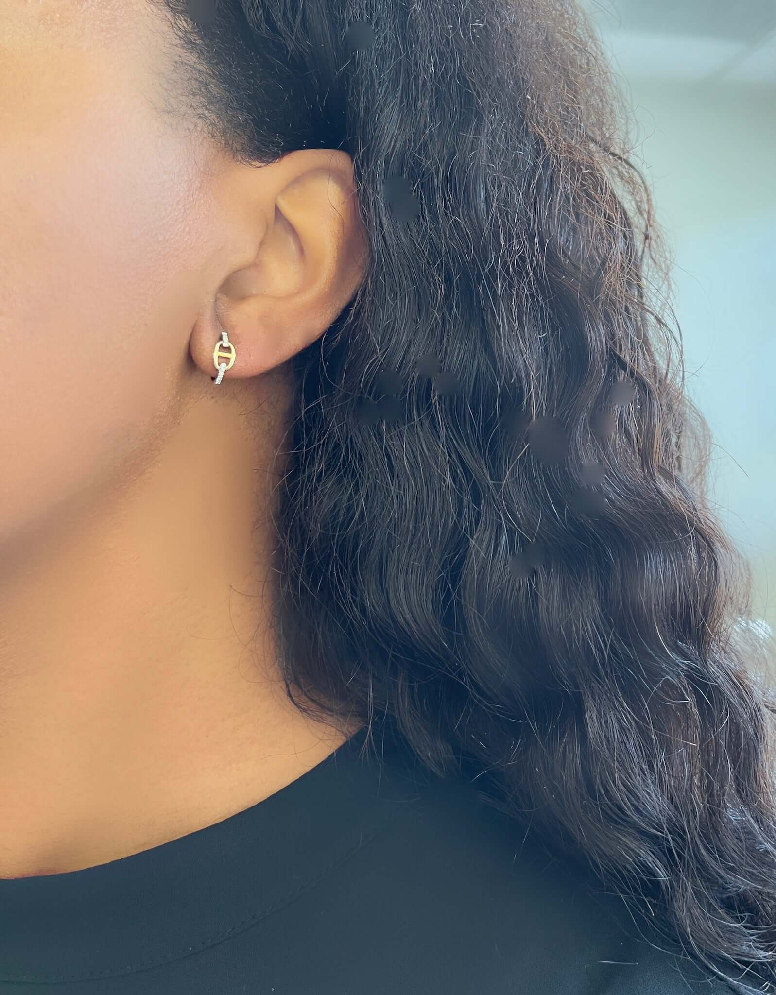 The Diamond Link Evie Huggies from Janet Heller Fine Jewelry are crafted in 14KT gold. The earrings feature a link design connected by diamonds. The small hoops can be worn alone or layered along the ear with other earrings.