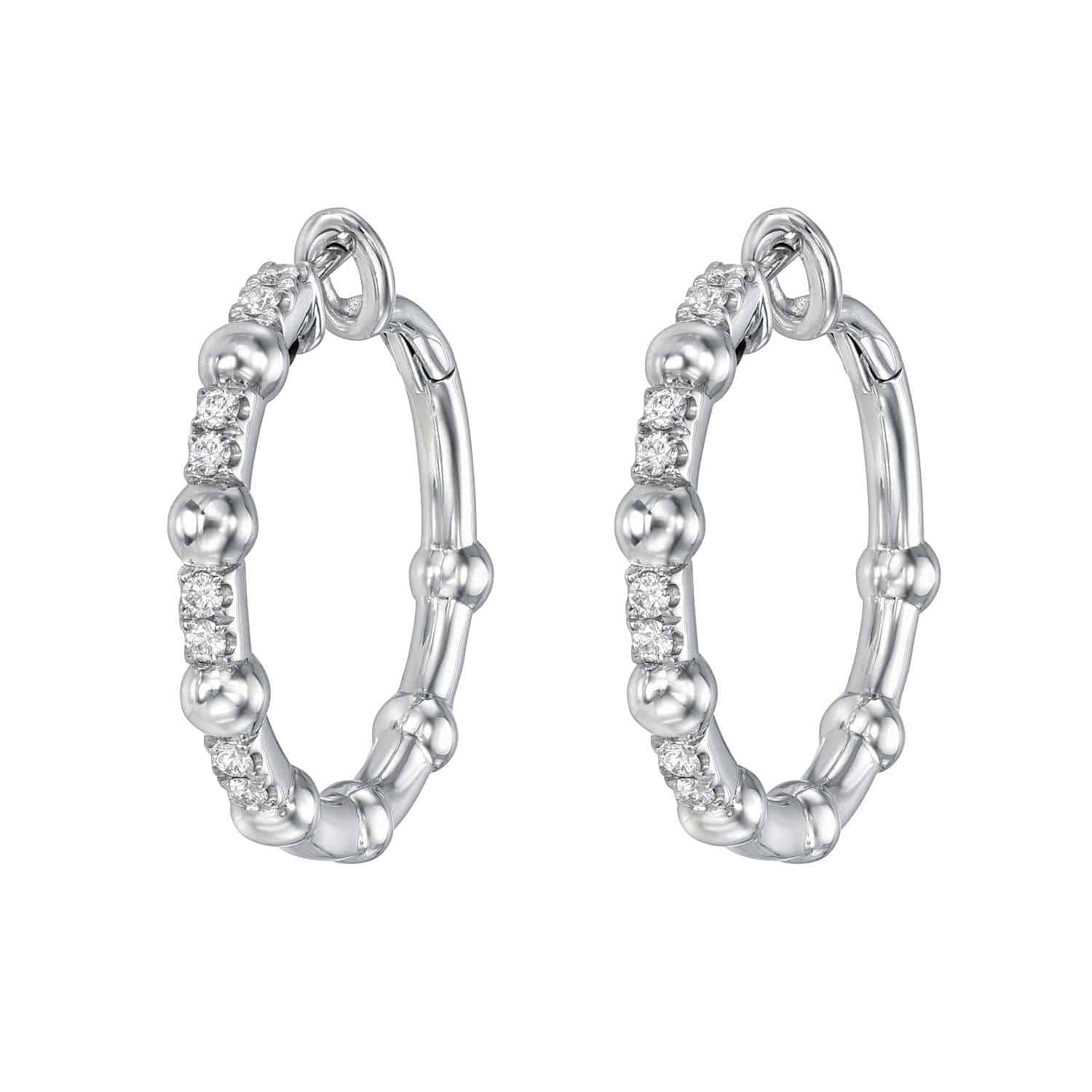 The Diamond Celeste Hoops from Janet Heller Fine Jewelry are crafted in 18KT gold. The earrings feature 16 small round diamonds. The color of the diamonds is G-H and the clarity is VS.