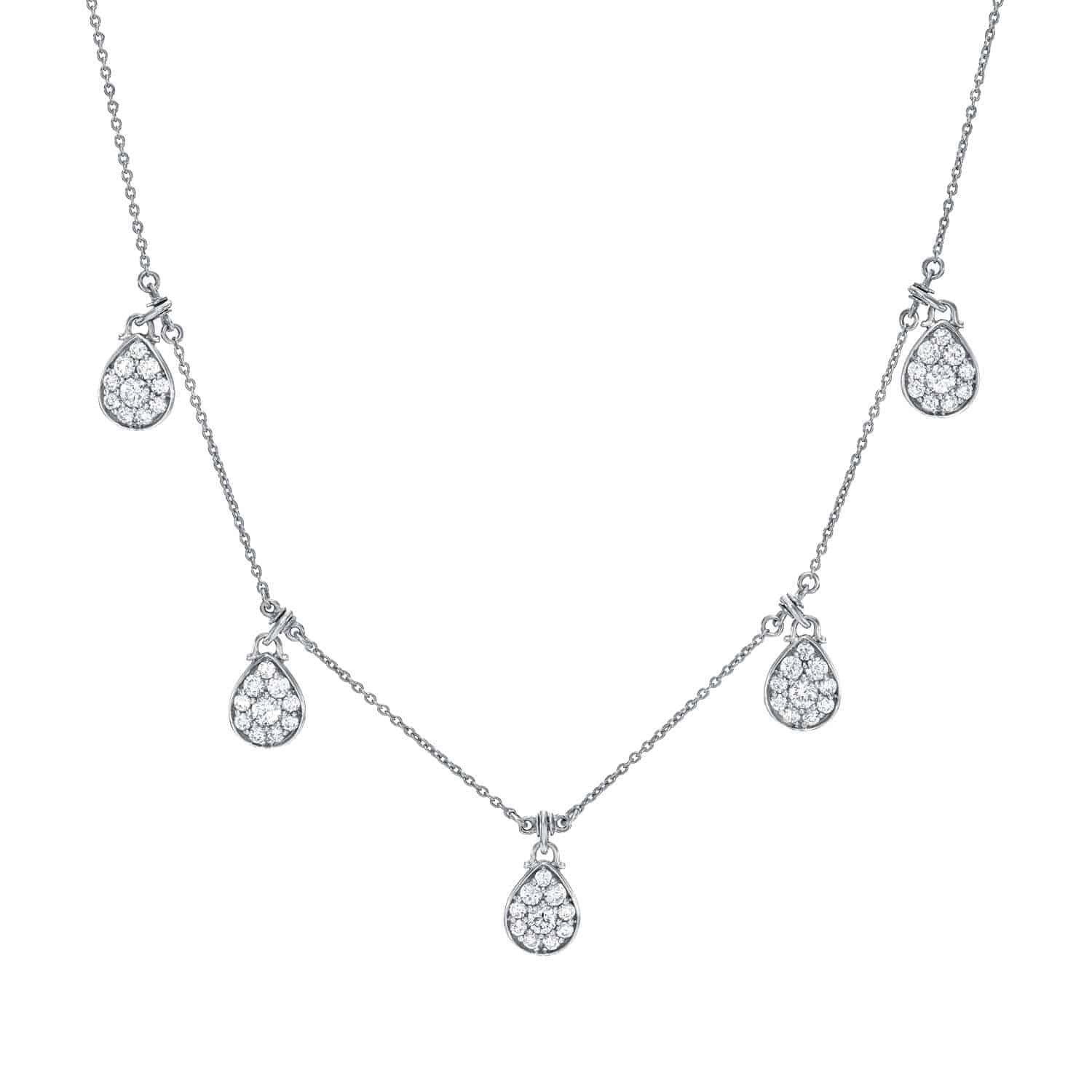 The Pear Drop Diamond Necklace is a delicate silver necklace adorned with five evenly spaced teardrop-shaped pendants, each encrusted with small, sparkling diamonds along a fine chain.