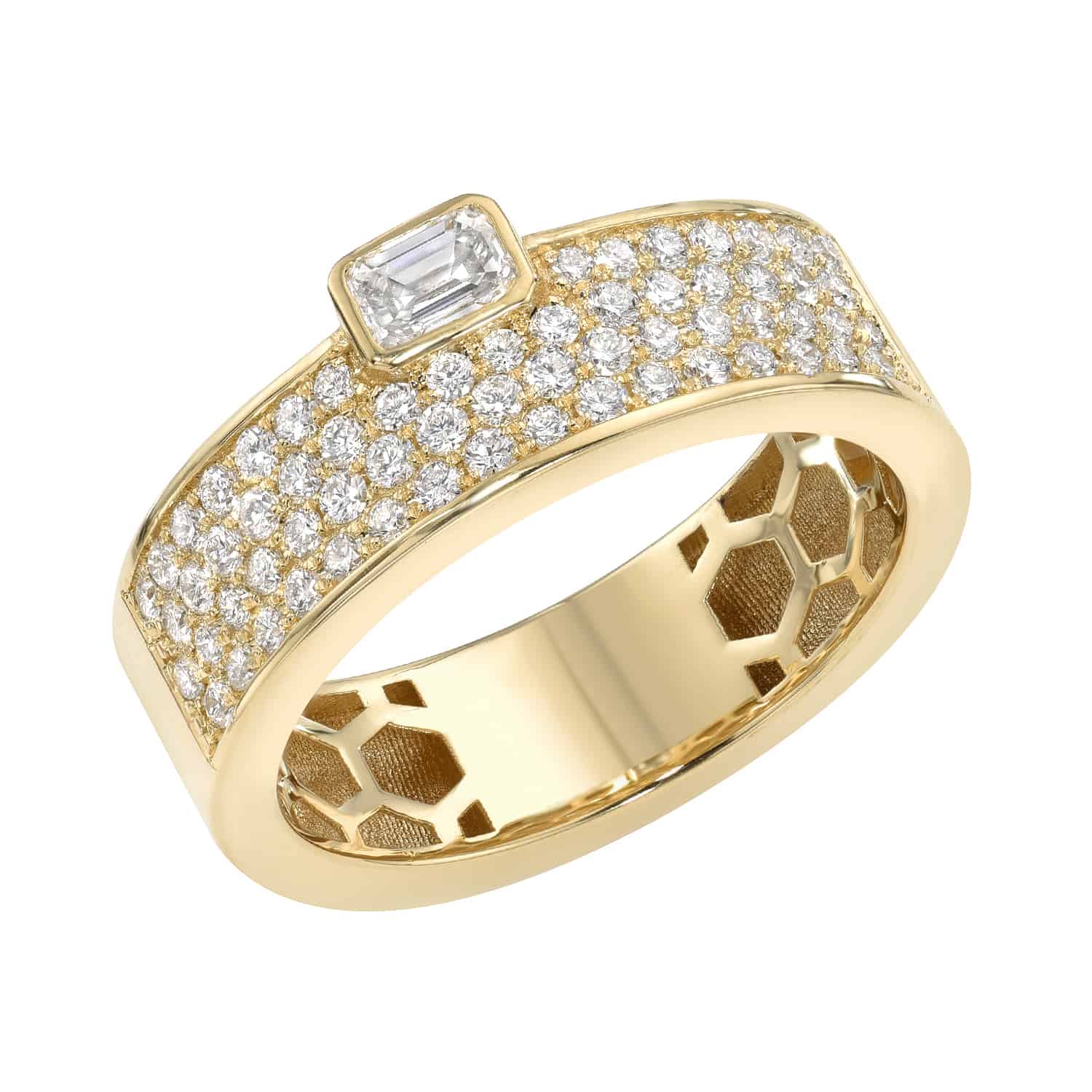 The Diamond Odette Ring, available for preorder, showcases a wide gold band studded with small diamonds. It highlights a central rectangular diamond and features a honeycomb design inside the band, exemplifying fine jewelry craftsmanship.