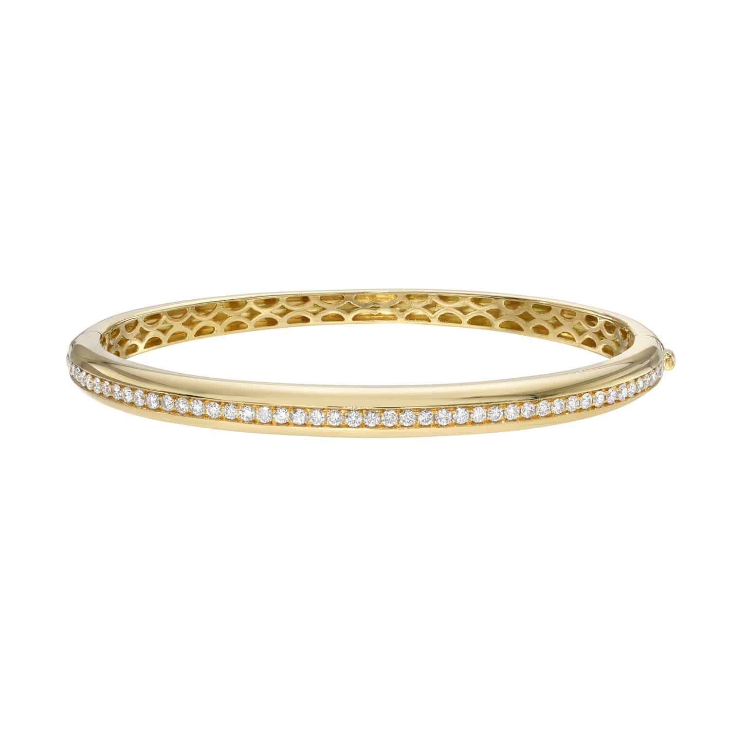 The Rounded Single Row Diamond Bangle features a sleek gold design with a row of round white diamonds on top and a honeycomb pattern inside.