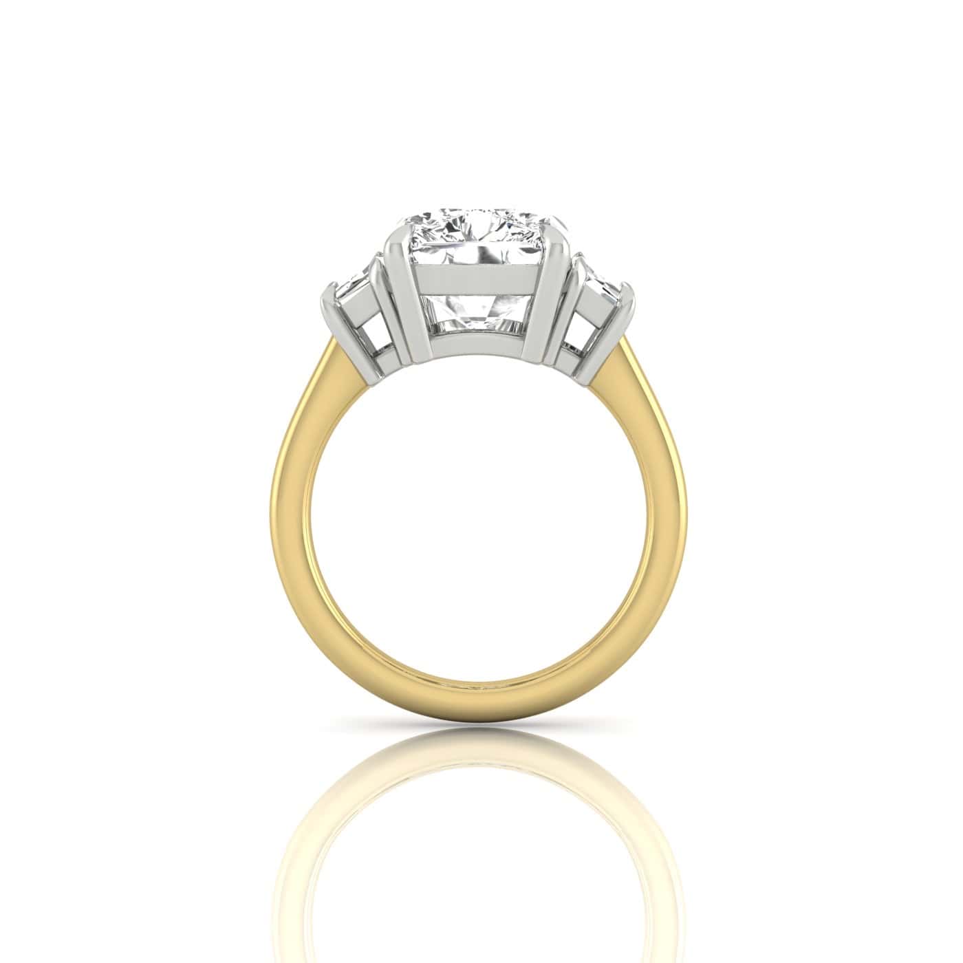 Side view of the Triad engagement ring featuring a large central diamond flanked by two smaller diamonds in a stunning 18KT gold triad setting. The polished gold band reflects light beautifully on a white background.