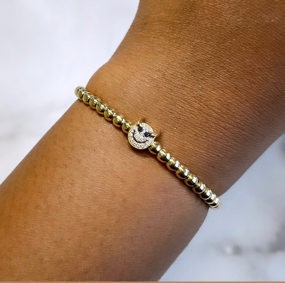 The Little Devil Stretchy Bracelet, part of the Mischief collection, features gold beads and a round charm with small diamonds. This elegant bracelet is available for pre-order now.