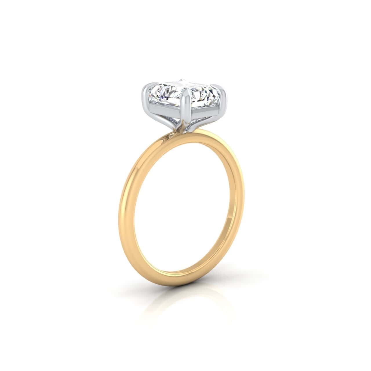 The Solitaire engagement ring is expertly crafted from 18KT gold and features a brilliant round diamond in a solitaire setting, accentuated by elegant silver prongs against a pristine white background.