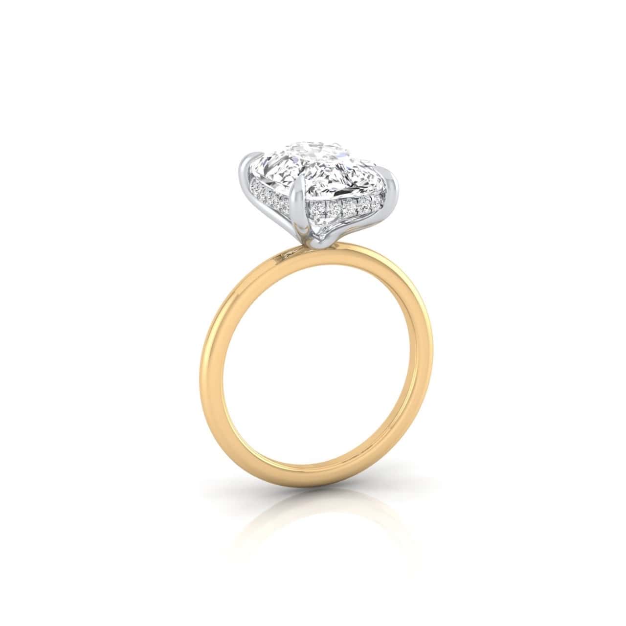 A gold ring named Solitaire + Hidden Halo features a square-shaped diamond on a prong mount with intricate casing detail. The elevated solitaire shines brilliantly, enhanced by a hint of hidden halo, and is showcased vertically against a white background.