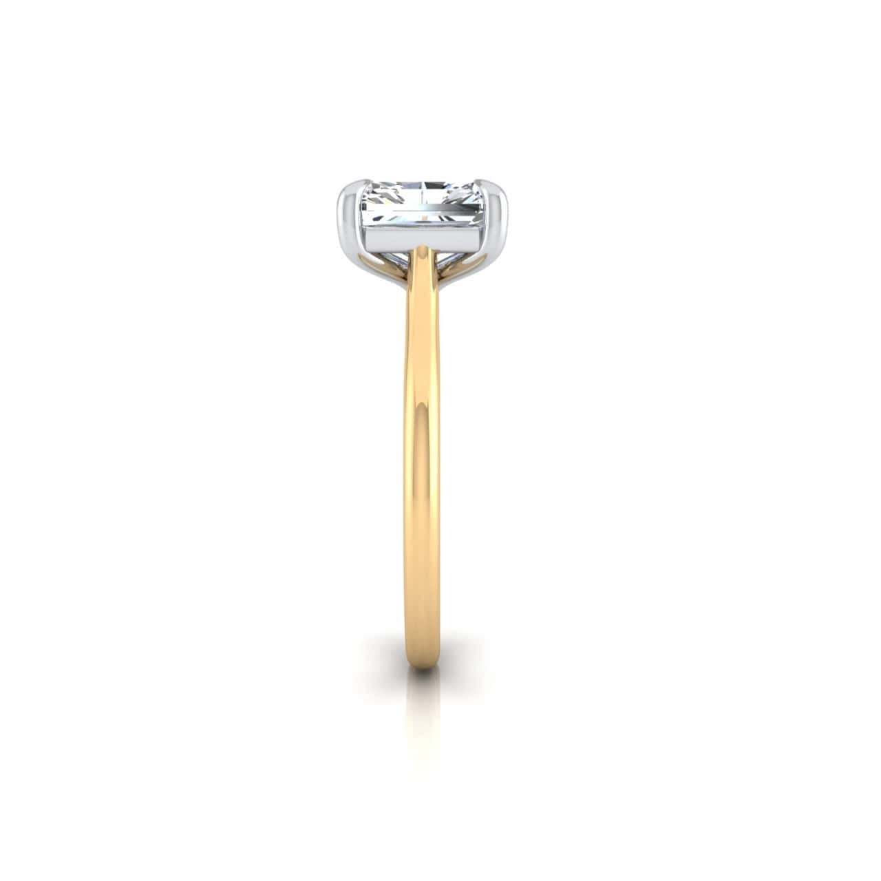 The Solitaire ring features a thin 18KT gold band with a large, clear square-cut diamond in a silver prong solitaire setting. It stands upright on a white background, showcasing its elegant and minimalist design.