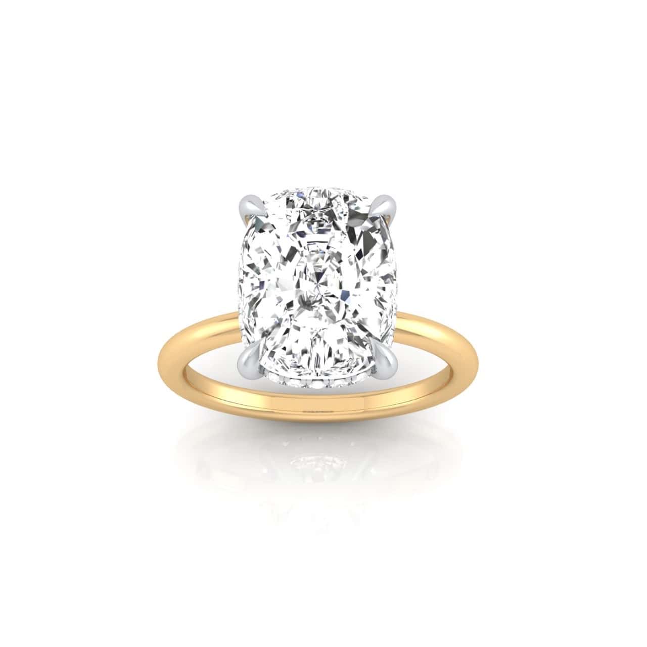 The Solitaire + Hidden Halo features a stunning cushion-cut diamond set in a four-prong setting, highlighted by a hidden halo. The gleaming diamond is centered on a white background, with its smooth, shiny band enhancing its brilliance.