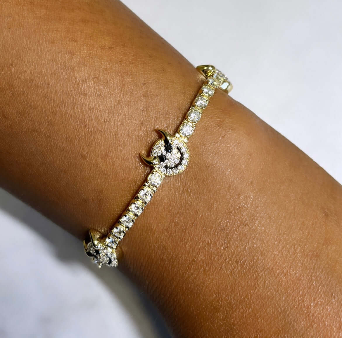 The Tricky Devil Tennis Bracelet from Janet Heller Fine Jewelry is crafted in 14KT gold.  The bracelet features black and white diamonds.  The bracelet can be worn alone or stacked with other bracelets.