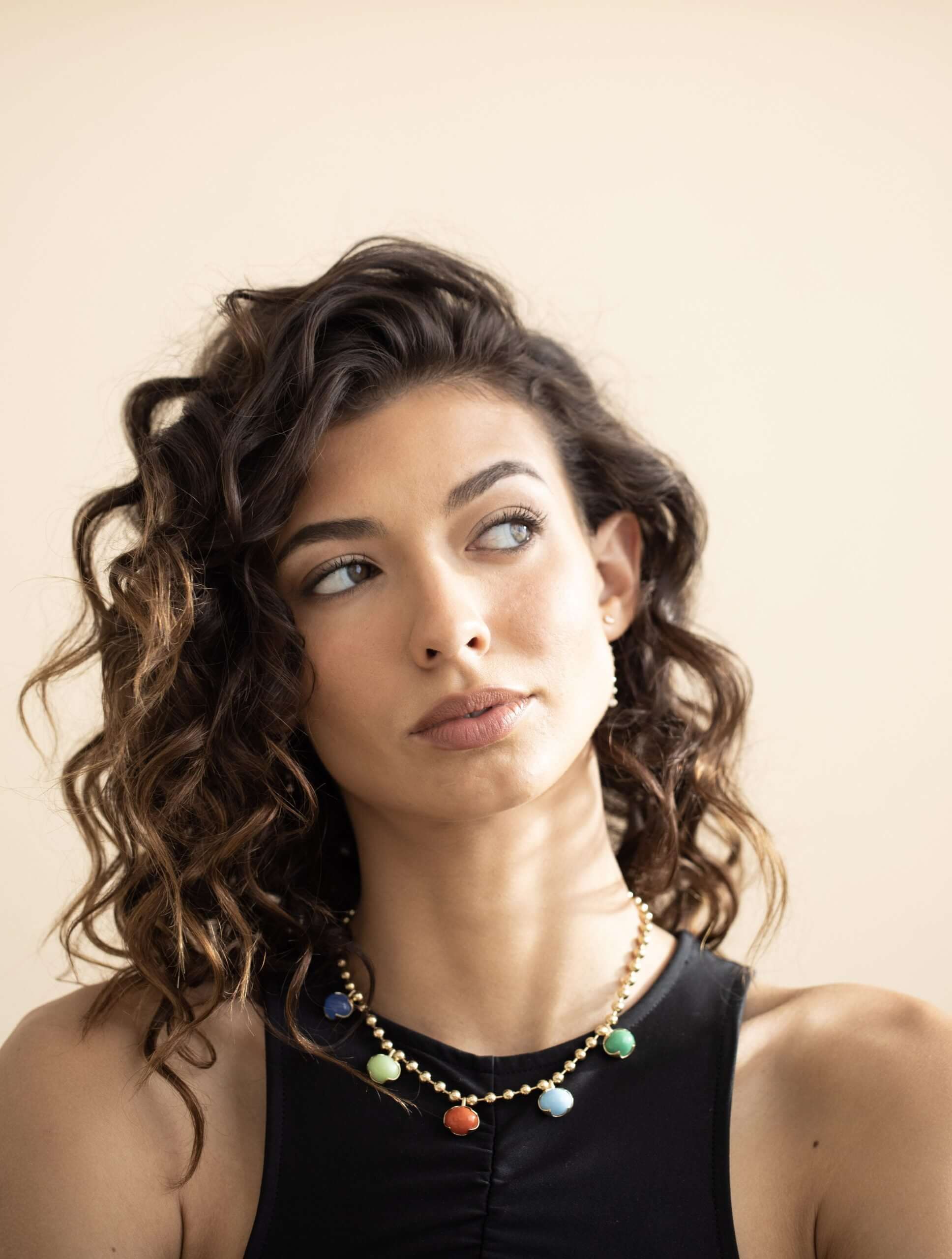 The Mixed Colored Stone Necklace from Janet Heller Fine Jewelry is crafted in 14KT gold. The necklaces features gold beads and colorful round pendants in blue, orange, green, light green and light blue.