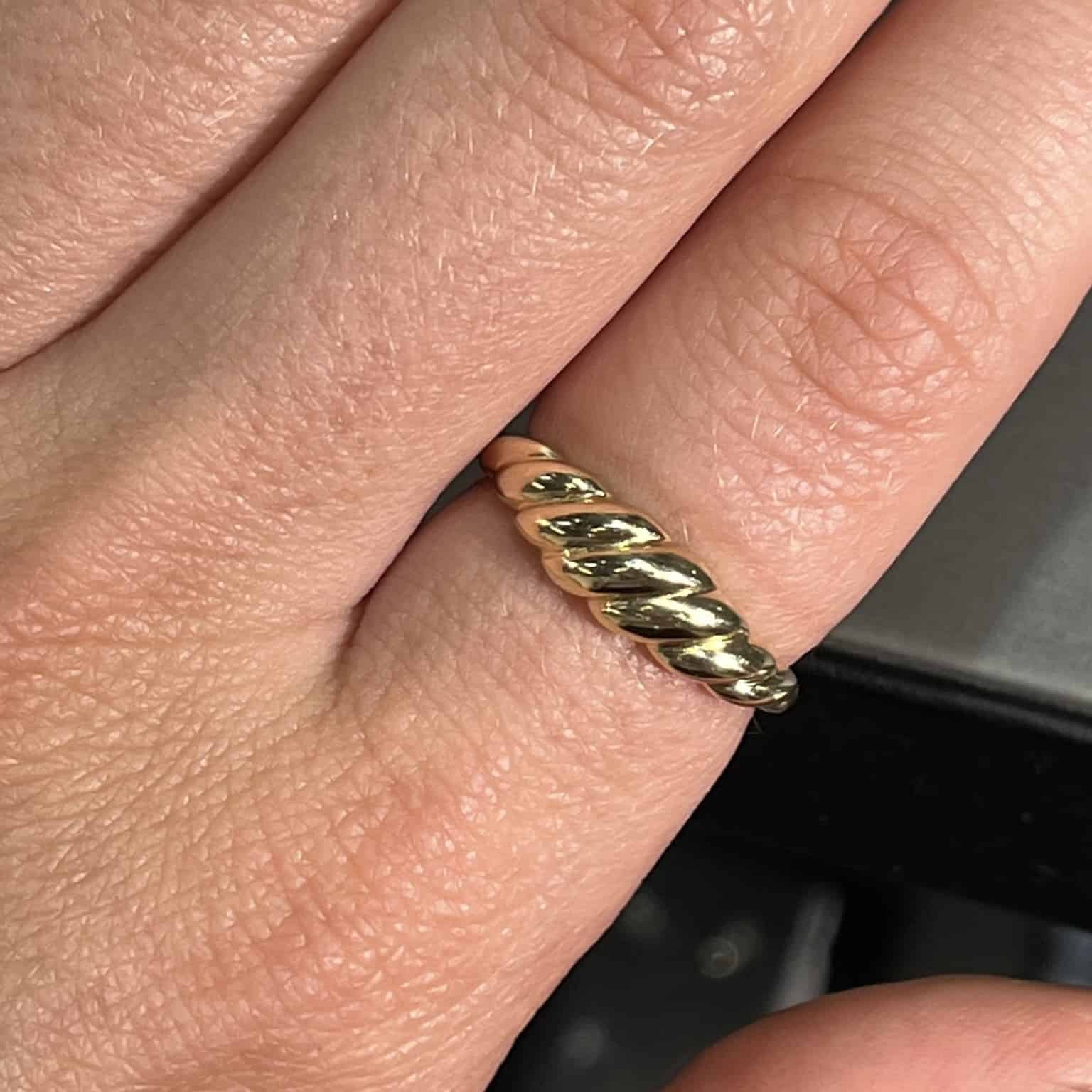 The Plain Gold Croissant Ring from Janet Heller Fine Jewelry is crafted in 14KT gold. The twisted band can be worn alone or stacked with other rings.