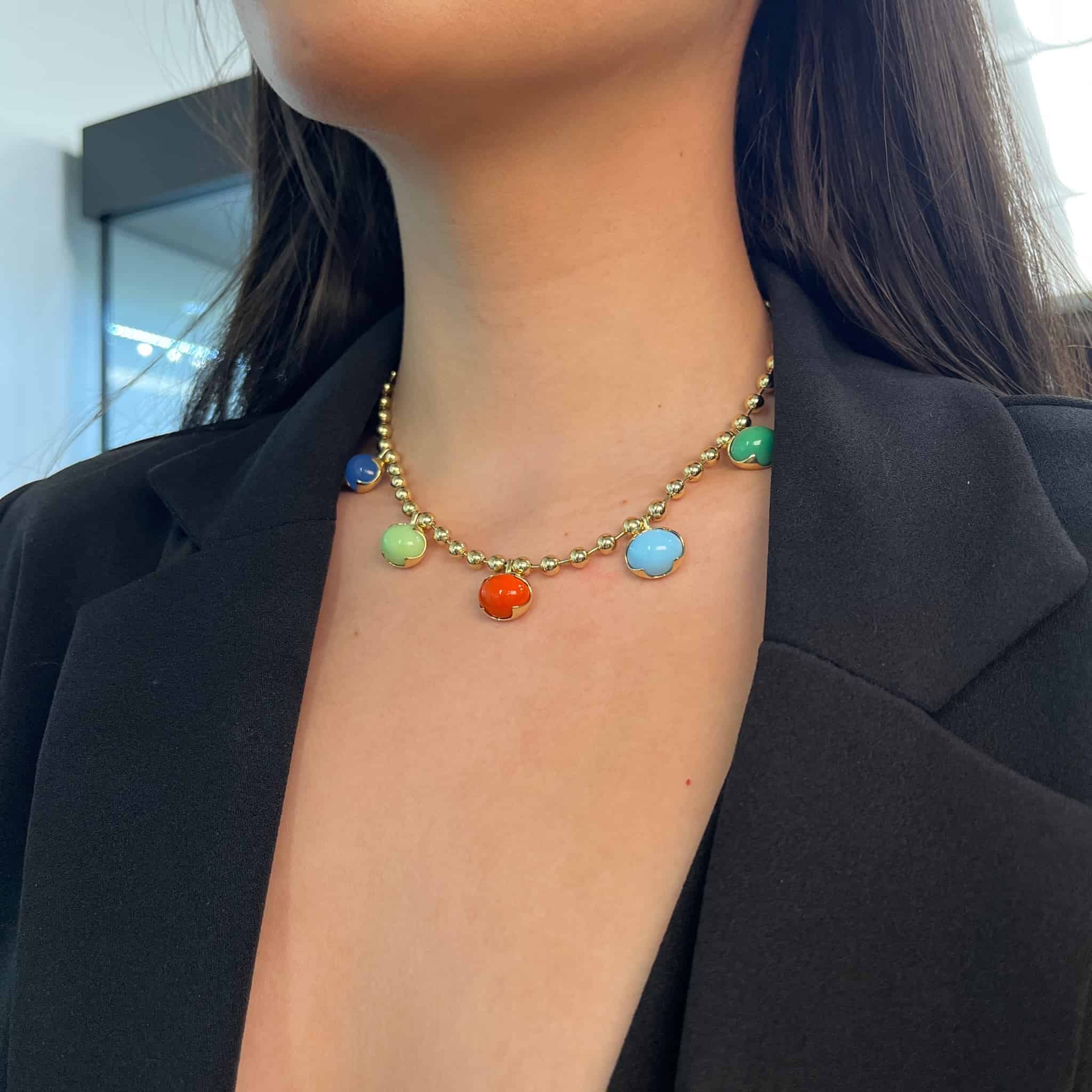 The Mixed Colored Stone Necklace from Janet Heller Fine Jewelry is crafted in 14KT gold. The necklaces features gold beads and colorful round pendants in blue, orange, green, light green and light blue.