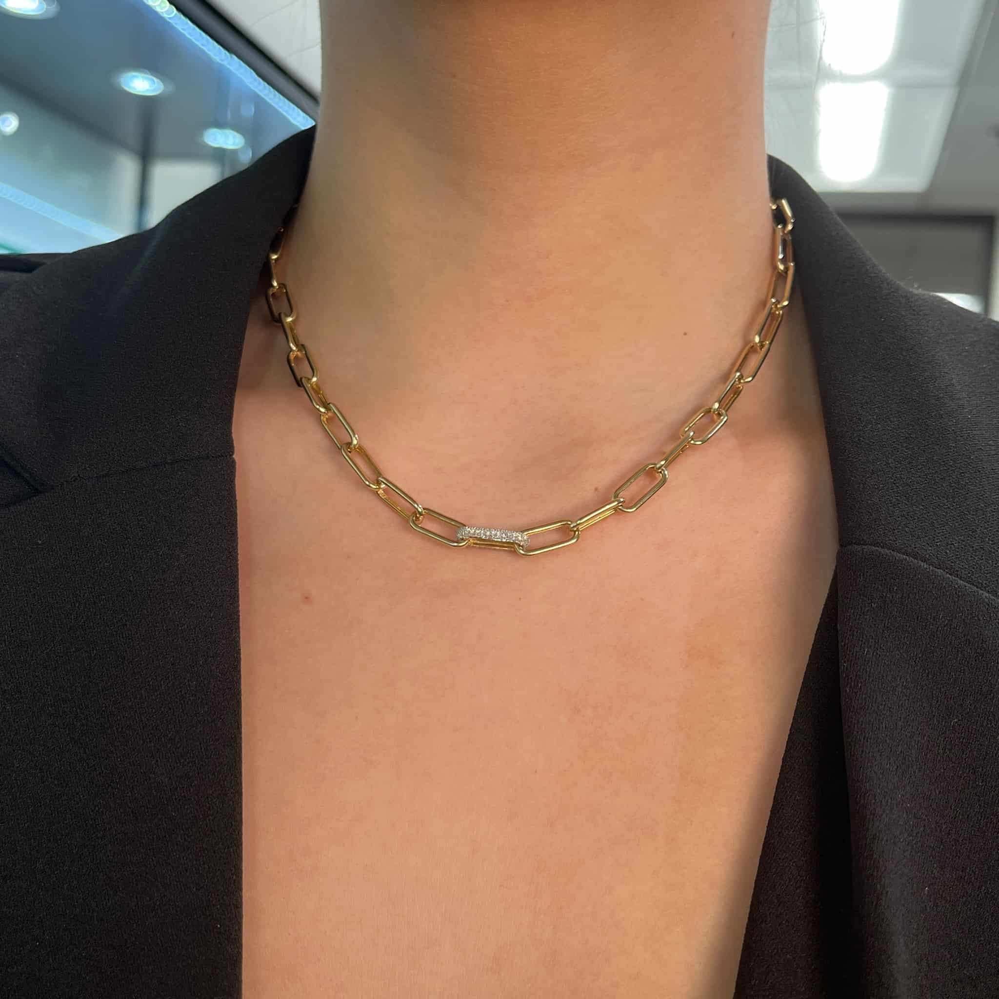 Wearing the JanetHellerFineJewelry Single Diamond Chain Link Necklace with rectangular links and an engraved plate, a person looks elegant in a black top, highlighting how customizations add unique charm.