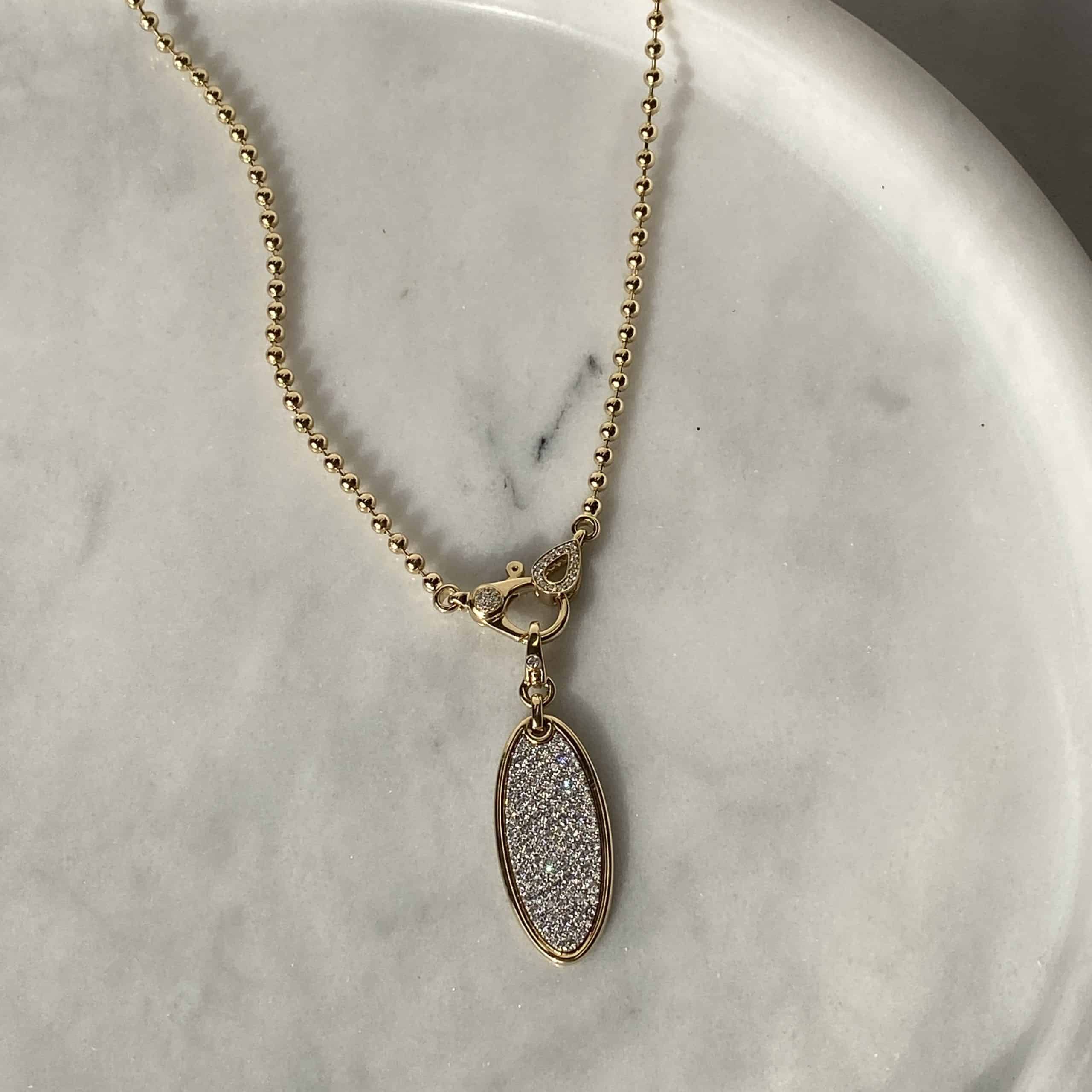 The 3mm Paris Chain from Janet Heller Fine Jewelry is crafted in 14KT gold. The necklace features a beaded chain with a diamond oval pendant and diamond clasp. It's the ideal necklace to showcase a Janet Heller Fine Jewelry charm.