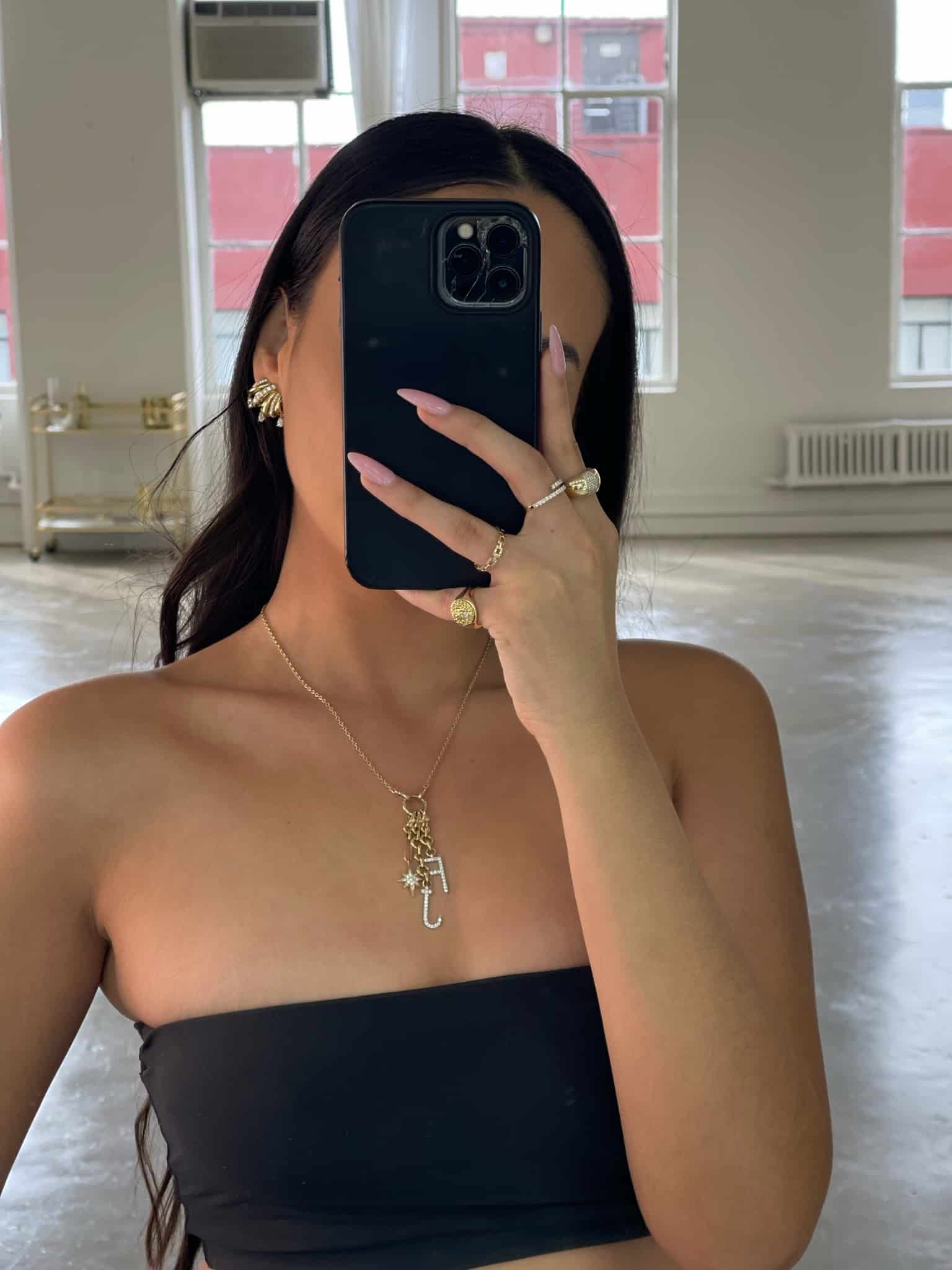 The Diamond Lola Initial Charm Necklace from Janet Heller Fine Jewelry is crafted in 14KT gold. The necklace features and adjustable chain with a gold charm holder adorned with a diamond star pendant. The diamond initial charms are available in any two letters of your choice. The necklace can be worn on its own or layered with other necklaces.