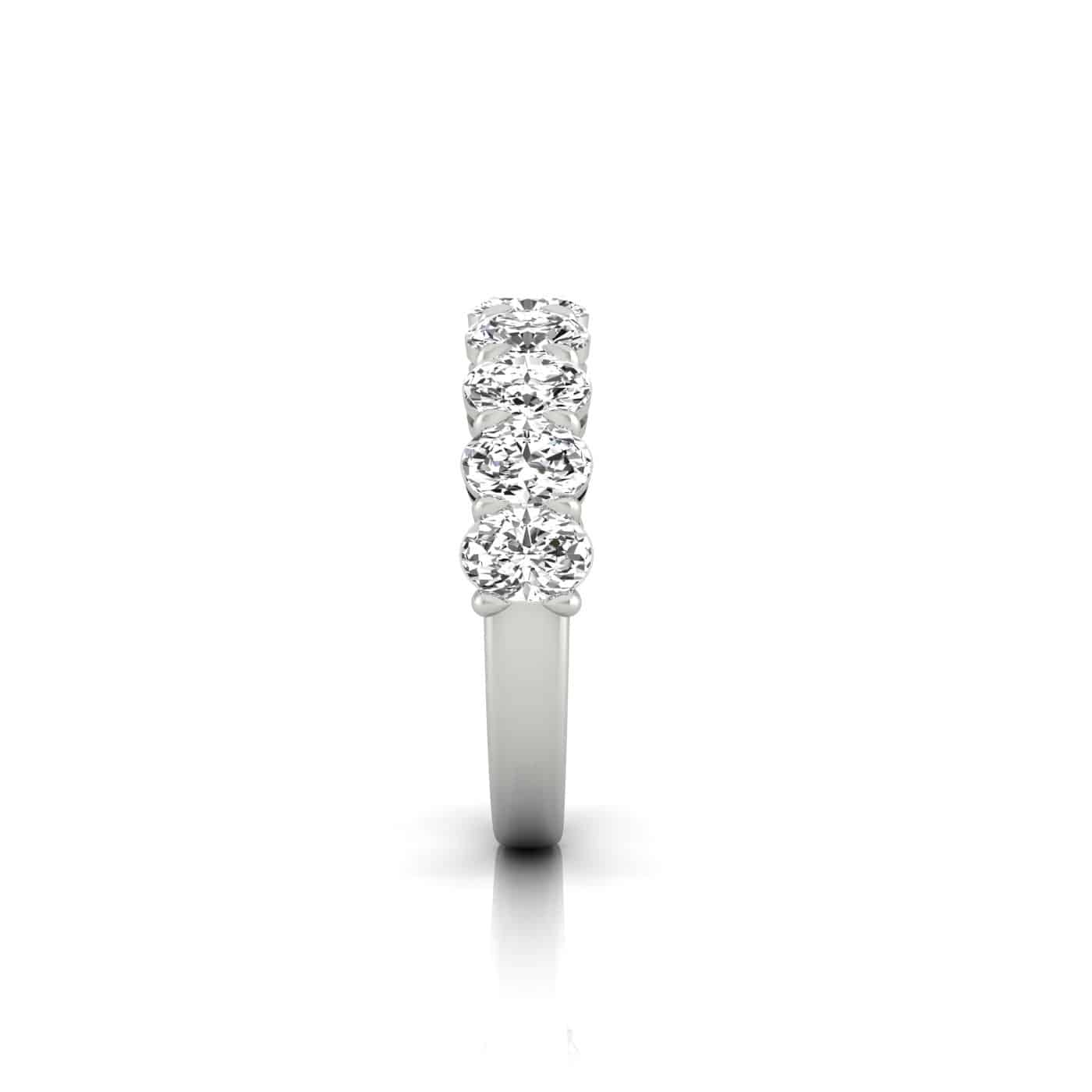 The Half Lab Grown Diamond Eternity Ring features a custom-made silver band with a vertical row of five sparkling round diamonds, enhancing its brilliance and perfectly complementing any 18KT gold accessories.
