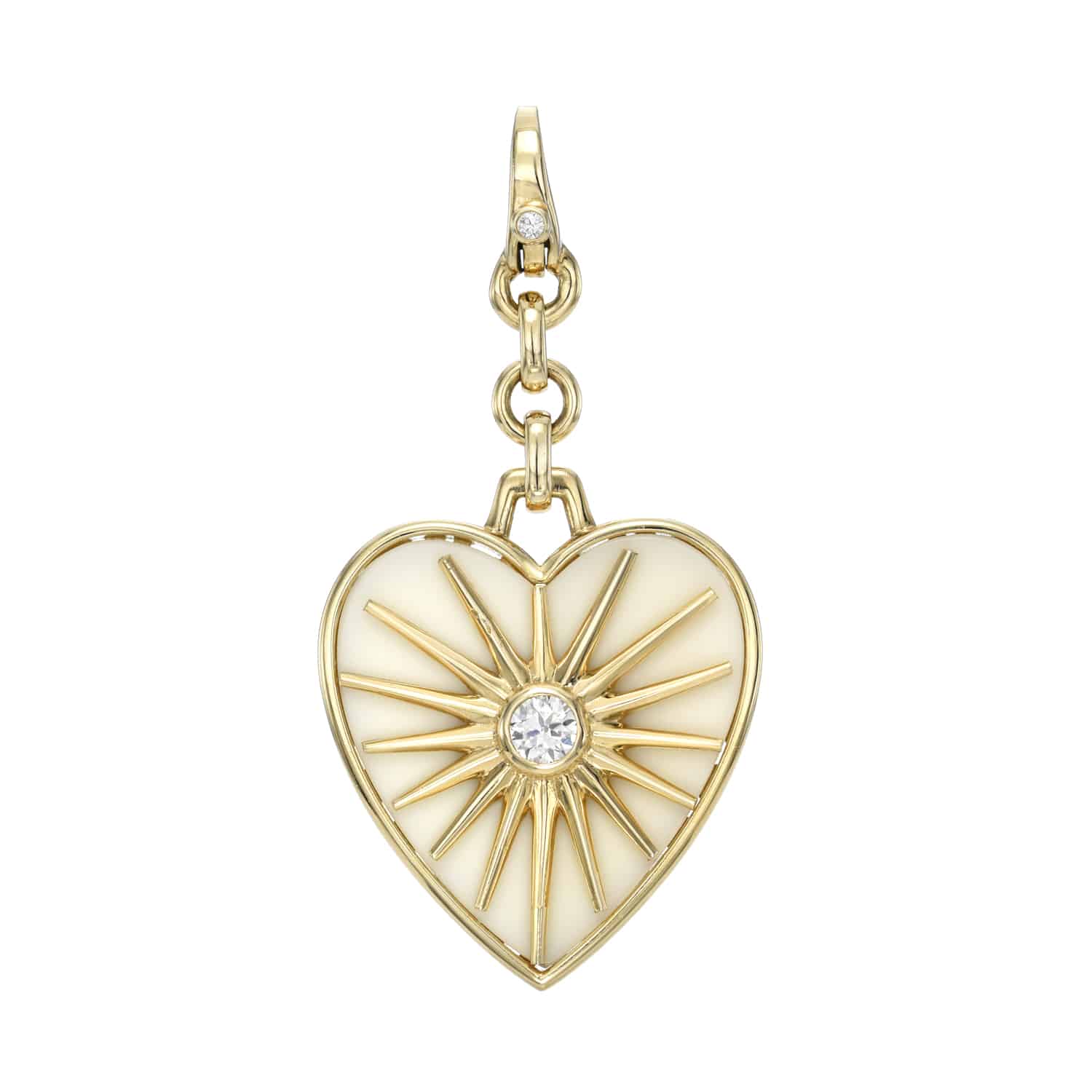 The Cacholong Sun Ray Charm from Janet Heller Fine Jewelry is crafted in 14KT gold. The heart-shaped pendant is set in cacholong with a sunburst design, featuring a center round diamond. The diamond clasp clips easily onto various Janet Heller Fine Jewelry chains and necklaces.