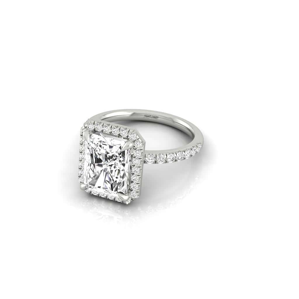 The Unity + Full Halo engagement ring from Janet Heller Fine Jewelry features a single prong-set center diamond on a U prong set pave diamond band and a full diamond halo.
The ring can be worn alone or stacked with your wedding band.