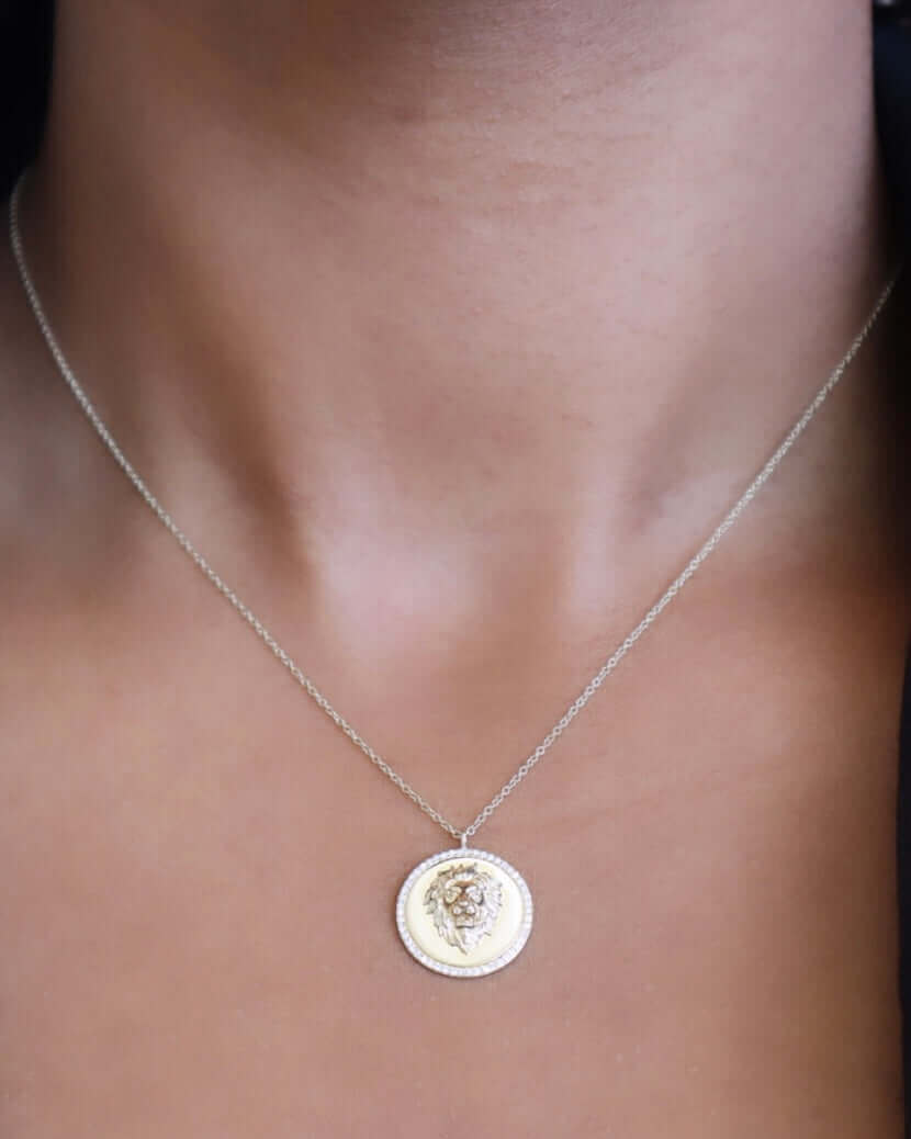 The Diamond Lion Pendant Necklace from Janet Heller Fine Jewelry is crafted in 14KT gold.  The charm is a round medallion with an edge made up of 50 small diamonds.  The necklace can be worn on its own or layered with other chains.