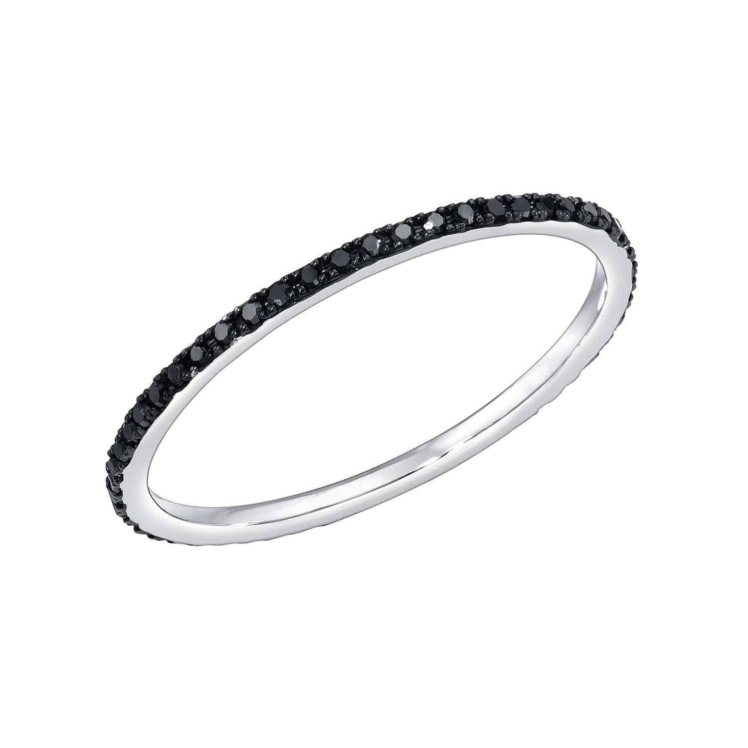 Black Rhodium Black Diamond Ring, priced at $387.00 (SKU: RIN-397-5-Y), features a slender silver band adorned with a continuous circle of small black stones and is offered as a preorder item from Janet Heller’s fine jewelry collection, shown against a white background.