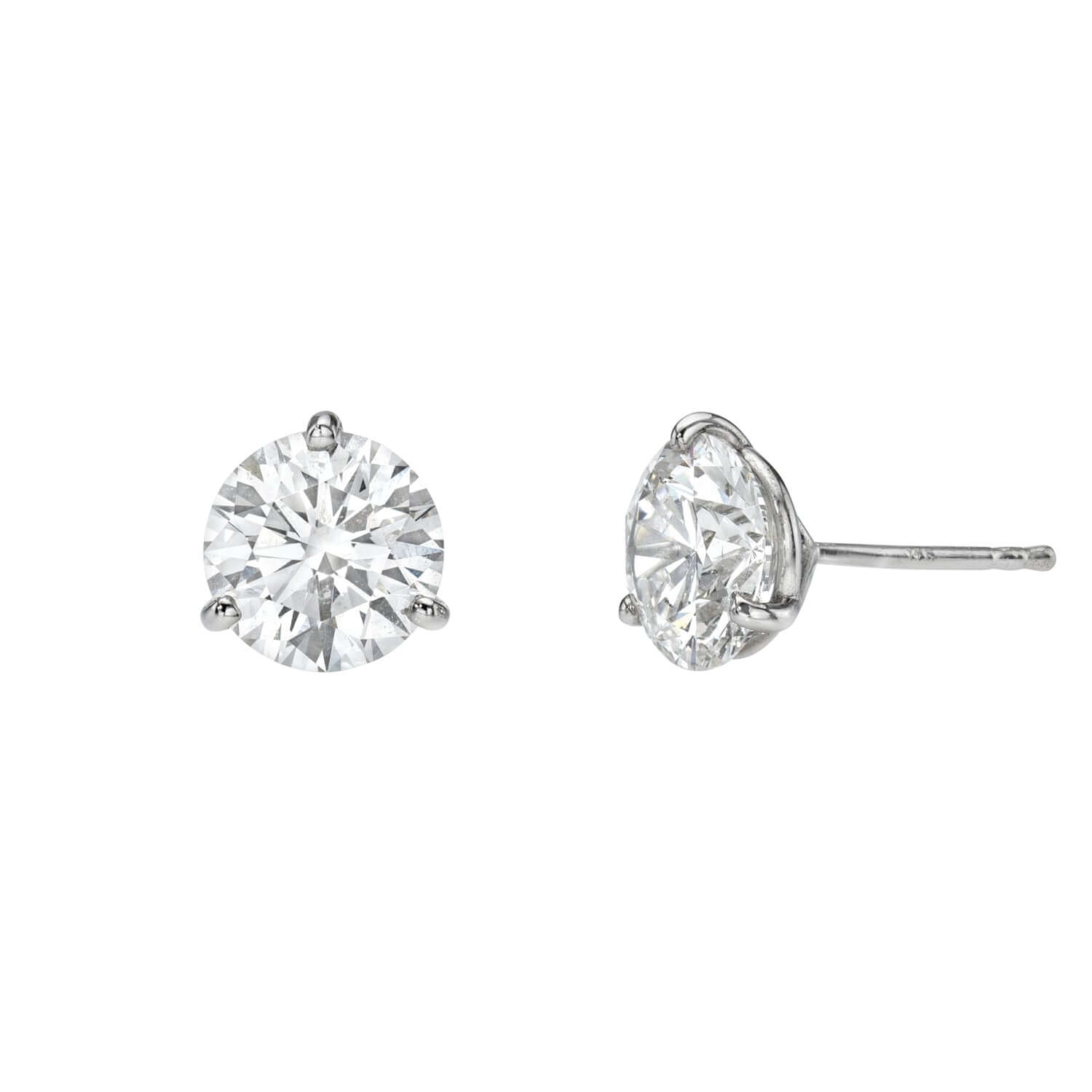A pair of Lab Diamond Studs with round stones set in silver prongs and posts, displayed from both front and side angles on a white background, exemplifies the timeless elegance of Janet Heller fine jewelry. For custom jewelry options or additional information about our jewelry, please contact us.