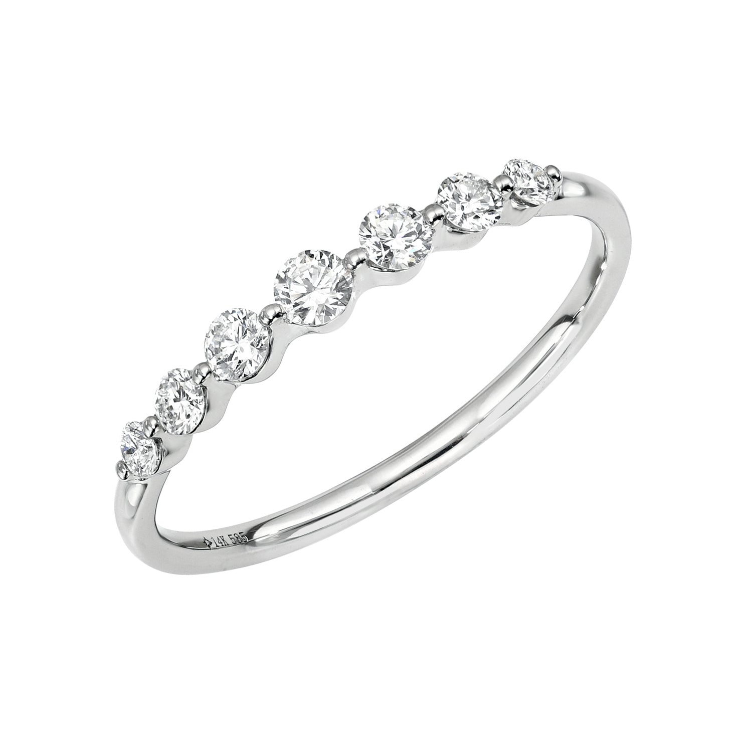 The 7 Diamond Samantha Ring features a delicate 14KT gold band adorned with seven sparkling round diamonds in minimal bezel settings—a timeless piece of fine jewelry.