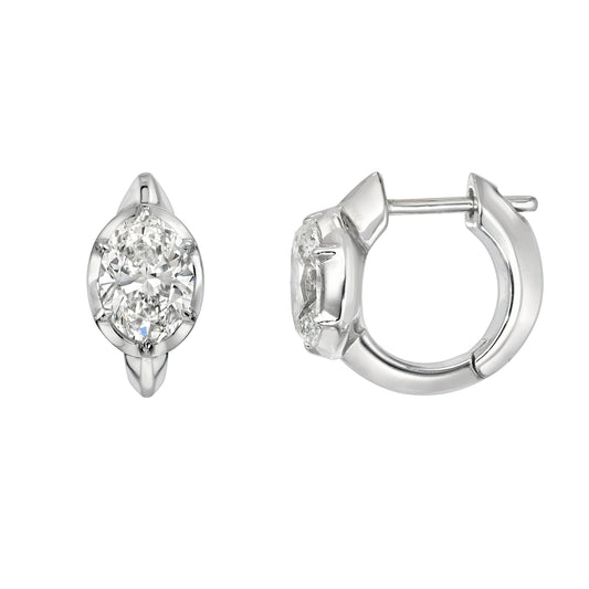 Lab Oval Bezel Diamond Huggies: Silver hoop earrings featuring oval-shaped lab diamonds set in bezels, shown from front and side views on a white background. A signature piece by Janet Heller Fine Jewelry.