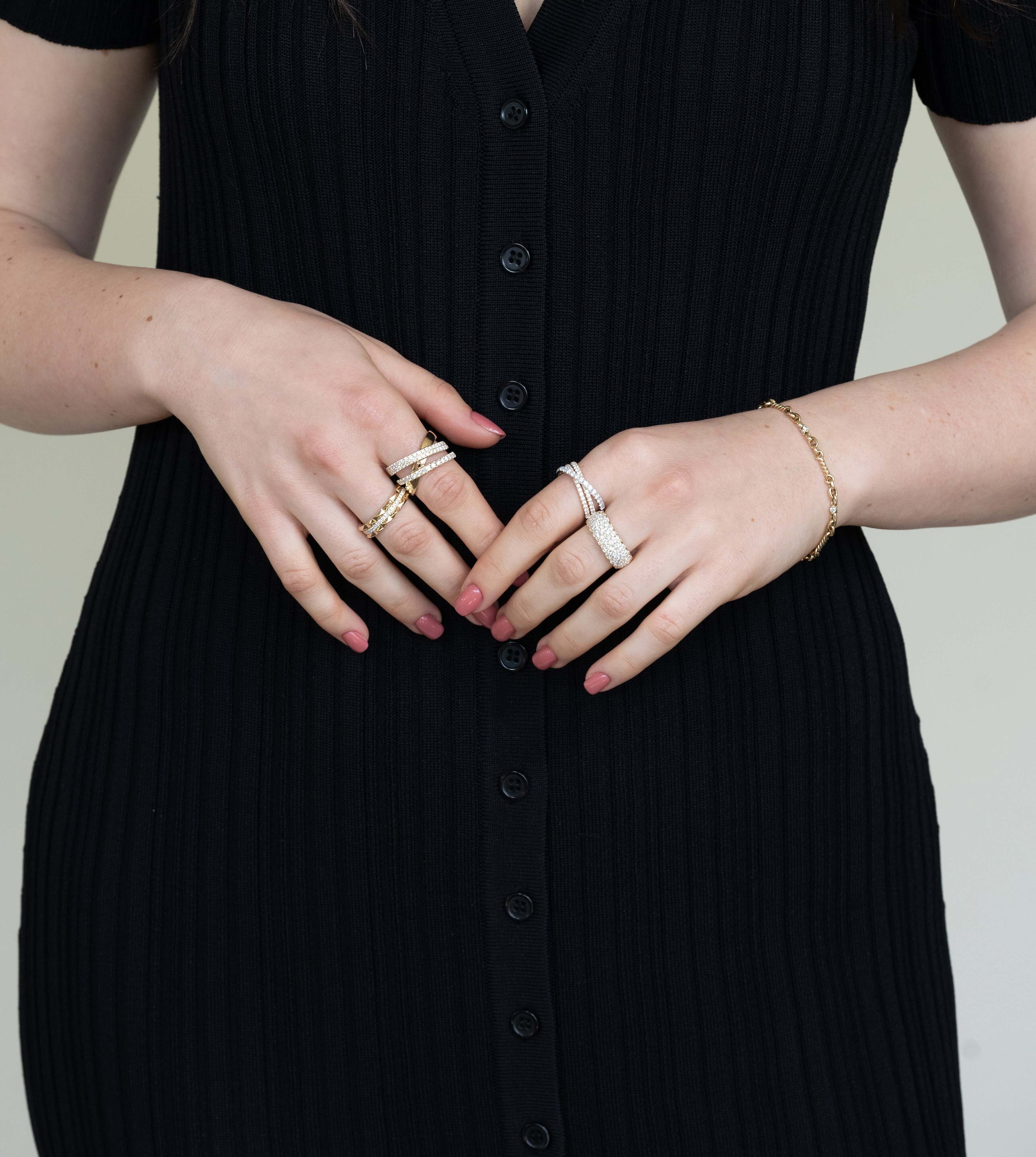 The Diamond Mosaic Ring from Janet Heller Fine Jewelry is crafted in 14KT gold.  The ring is encrusted with multiple diamonds in various sizes.  The band can be stacked or worn alone.
