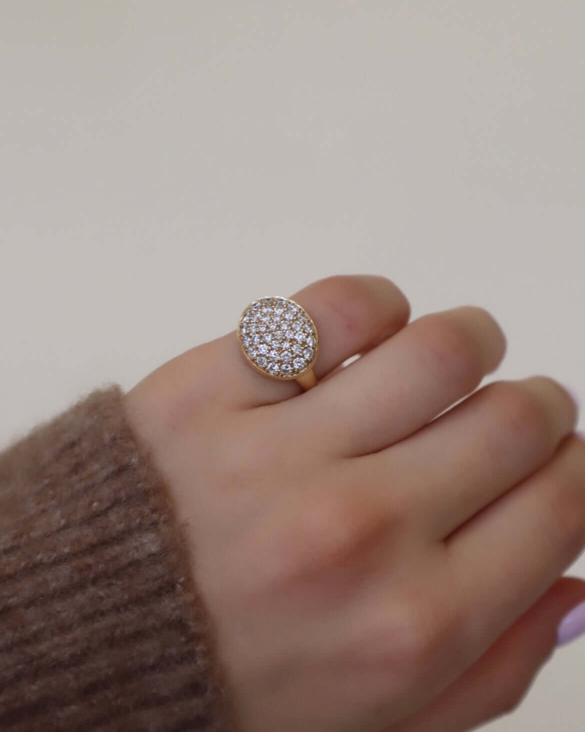 The Pave Diamond Oval Ring from Janet Heller Fine Jewelry is crafted in 14KT gold and features a large oval top encrusted with pave diamonds.