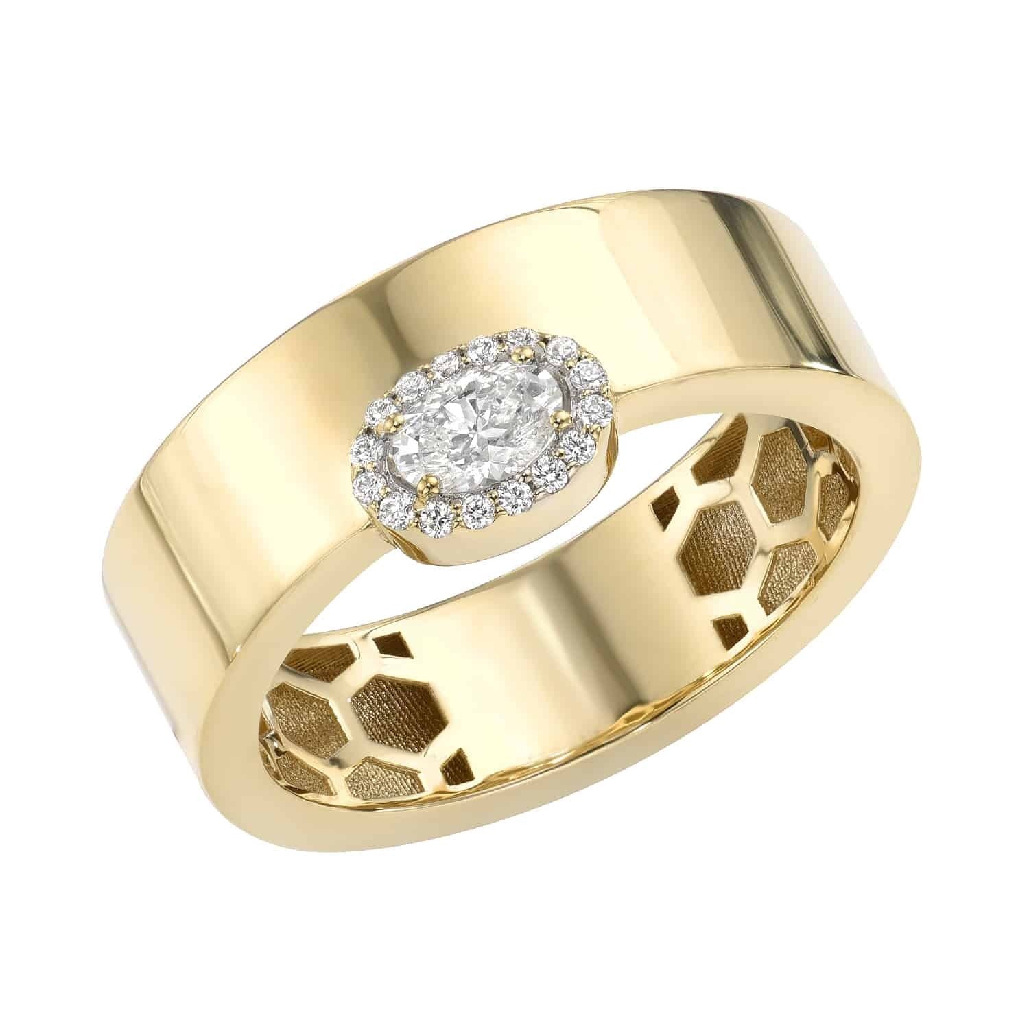 The Diamond Oval Cut Ring by Janet Heller is a wide gold band showcasing a central oval-shaped diamond encircled by smaller diamonds, with an intricate honeycomb pattern on the inner band. Available for preorder, this exquisite piece blends elegance and fine craftsmanship.
