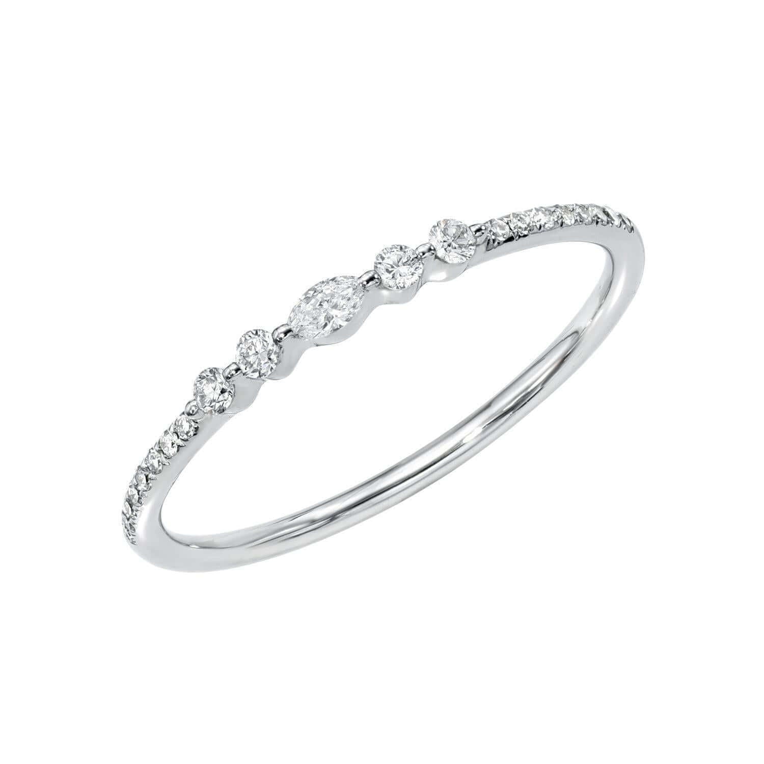 Introducing the Micro Diamond Marquise Stacking Ring—an elegant white gold ring from Janet Heller's fine jewelry collection. This refined design features a sparkling row of petite round diamonds, highlighted by a striking marquise-shaped diamond at the center, offering a timeless and sophisticated look. Available for preorder, it's the perfect choice for those who cherish classic elegance.