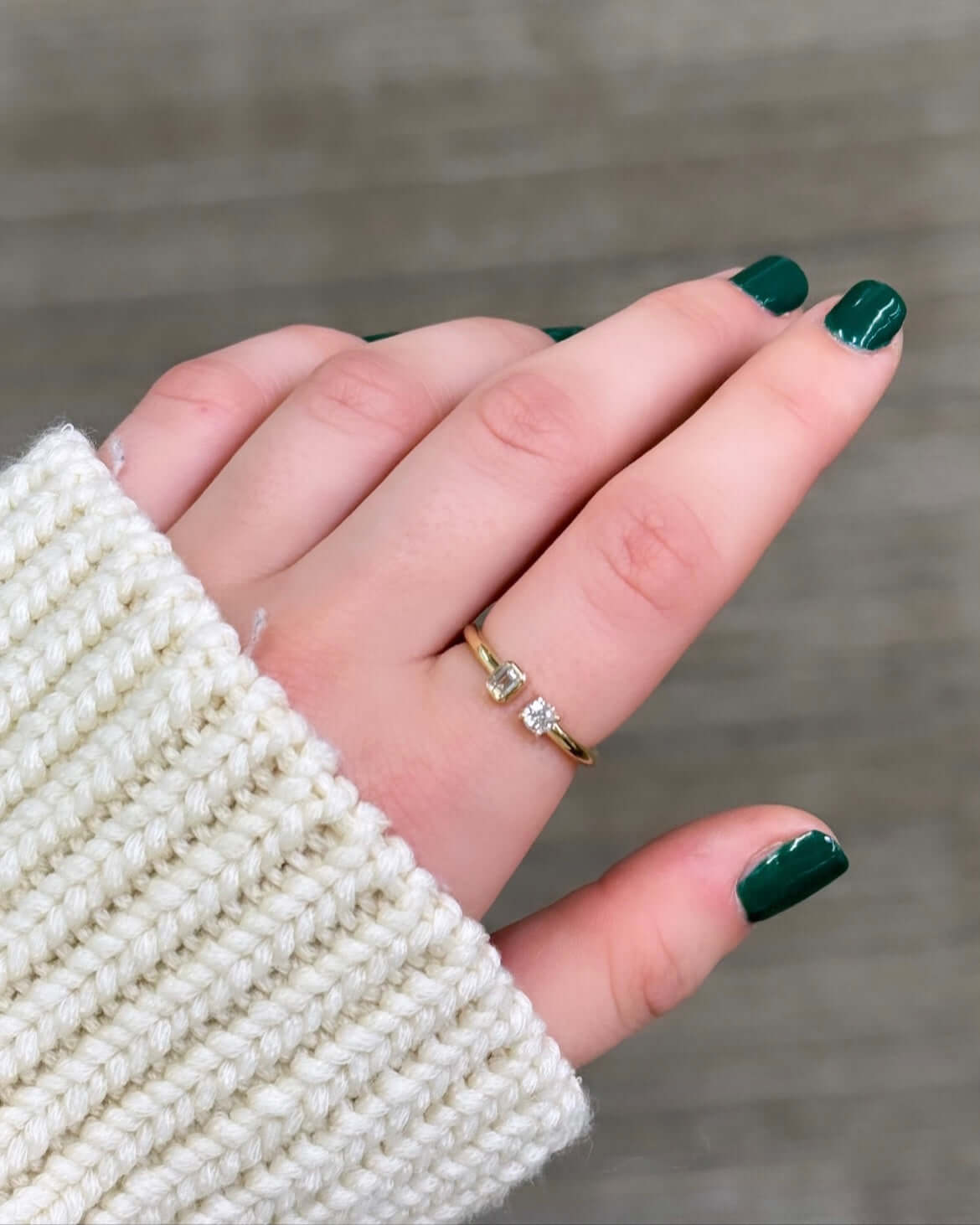 The Emerald & Round Toi Et Moi Ring from Janet Heller Fine Jewelry, is crafted in 14KT gold and features emerald and round-cut diamonds.  The emerald diamond is 0.15 carats in a bezel setting and the 0.15 carat round diamond is in a prong setting.  The ring can be stacked or worn on its own.